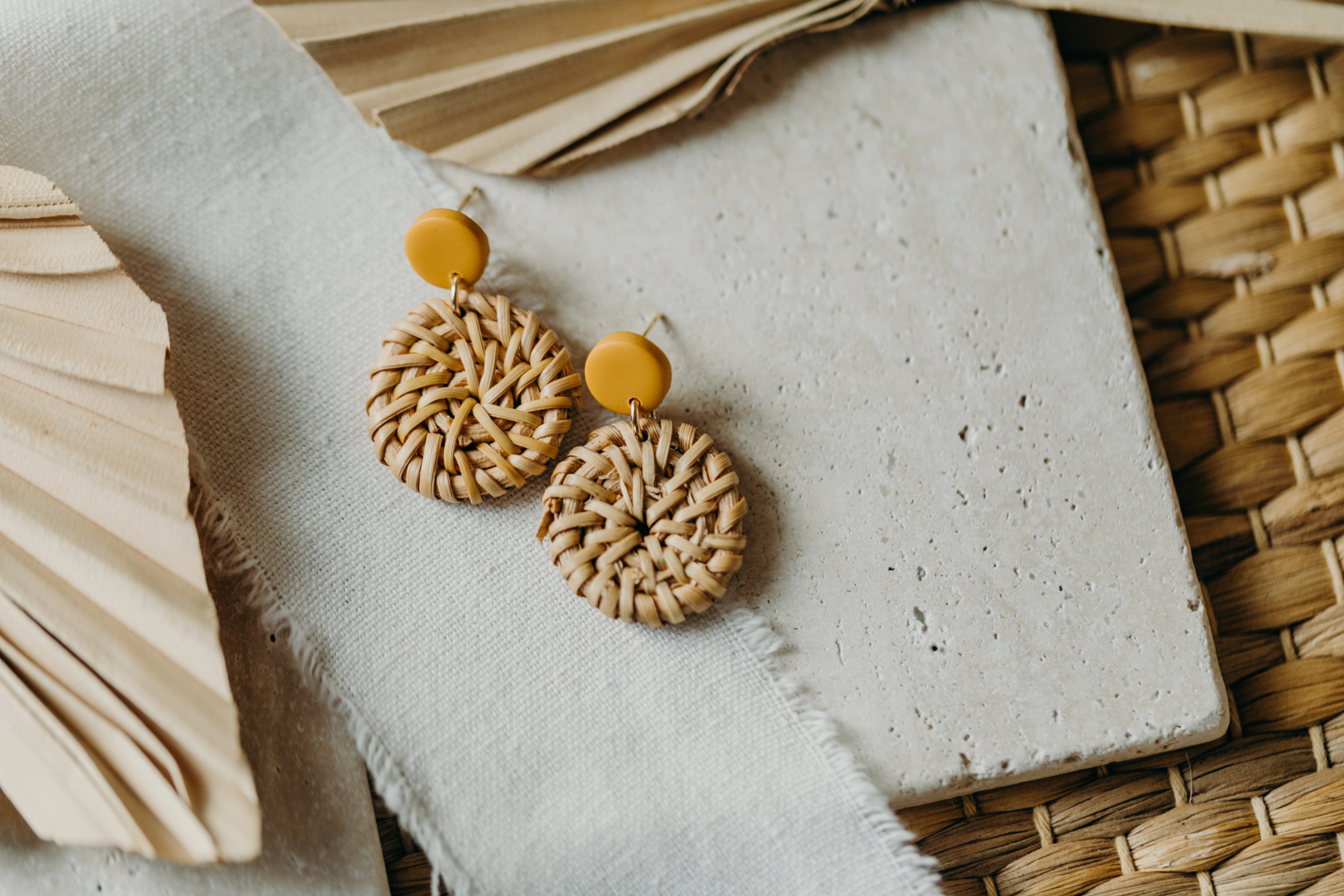 round polymer clay earrings in mustard yellow with round rattan pendant