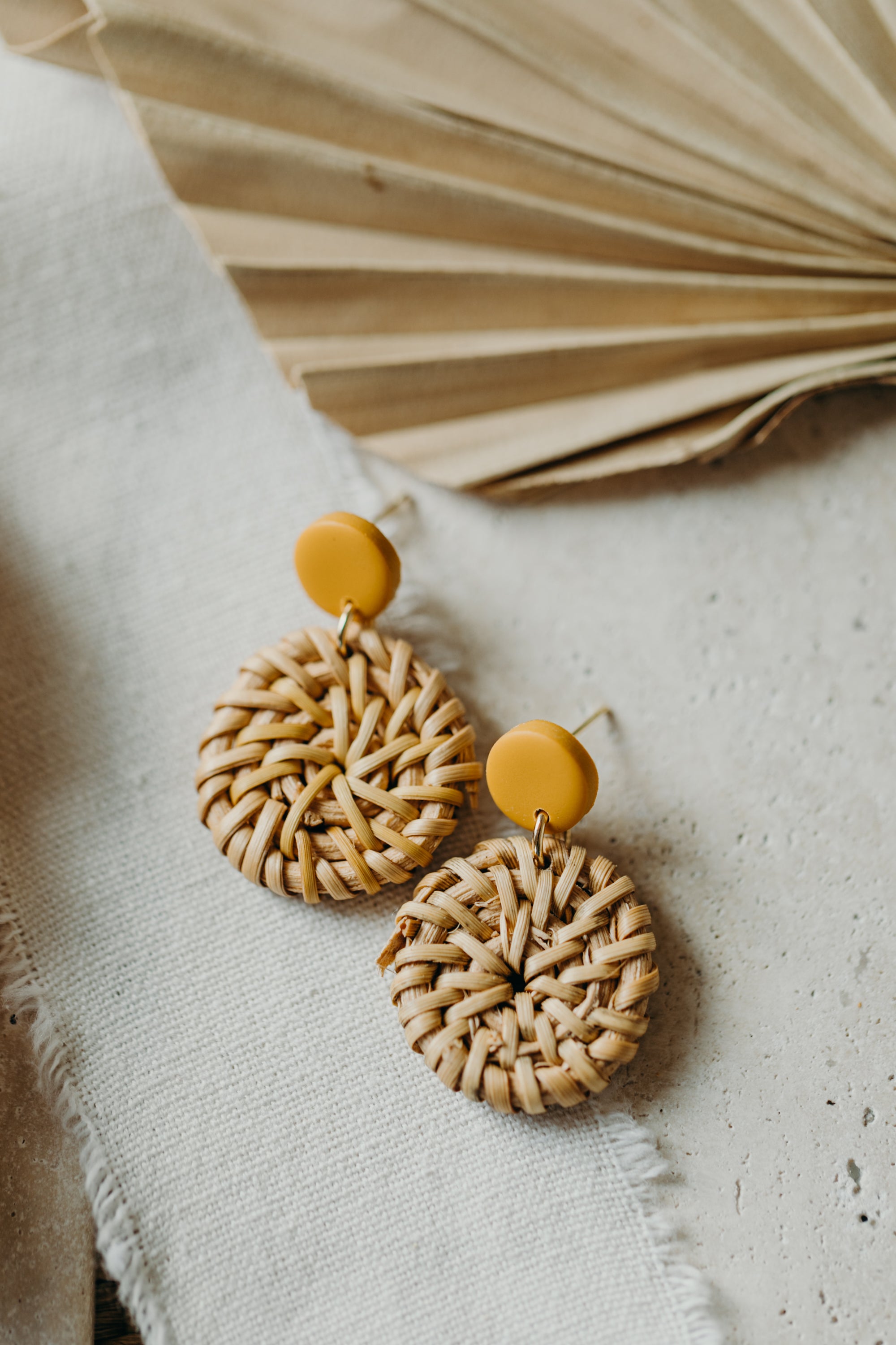 round polymer clay earrings in mustard yellow with round rattan pendant