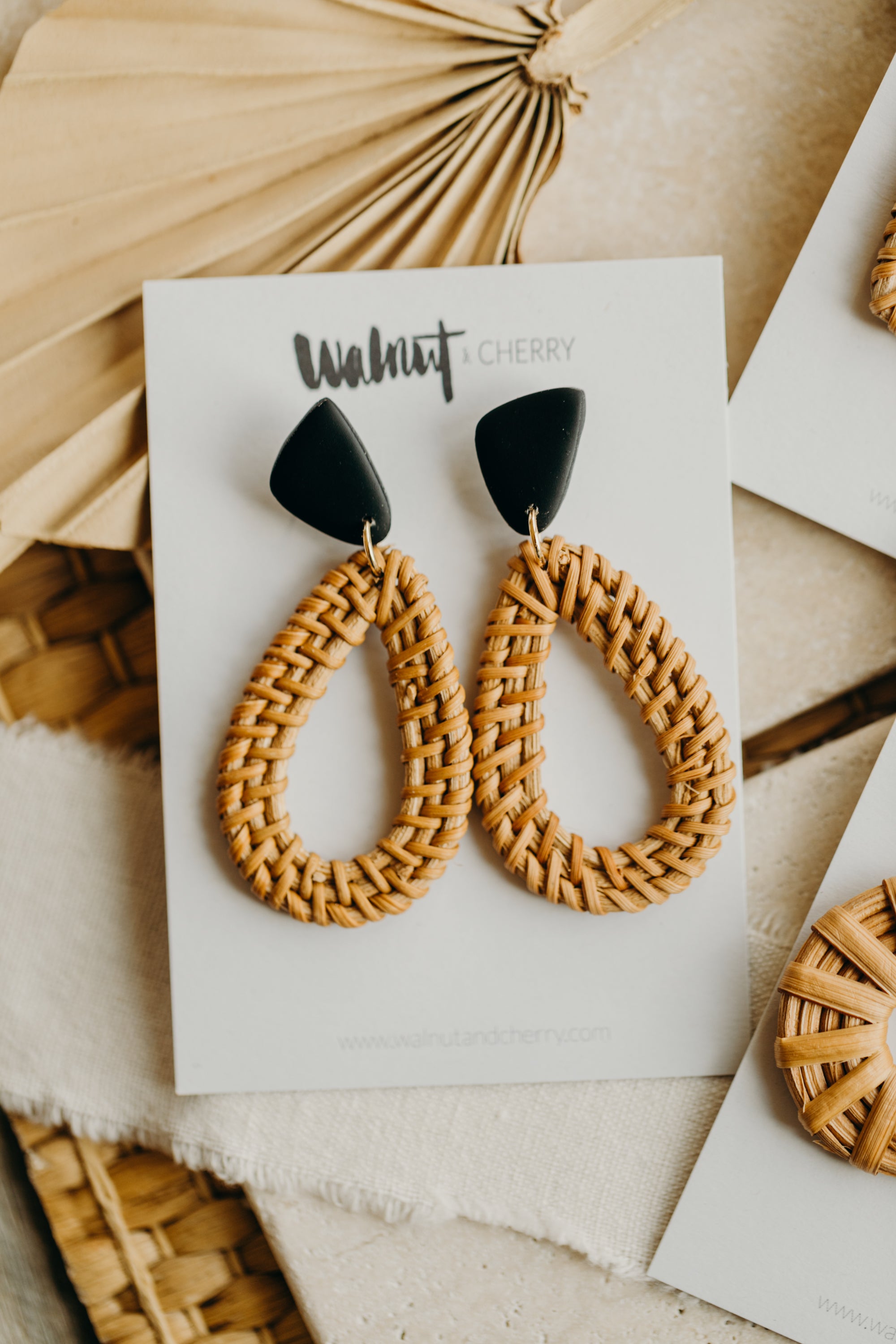 black polymer clay earrings with rattan pendant drops