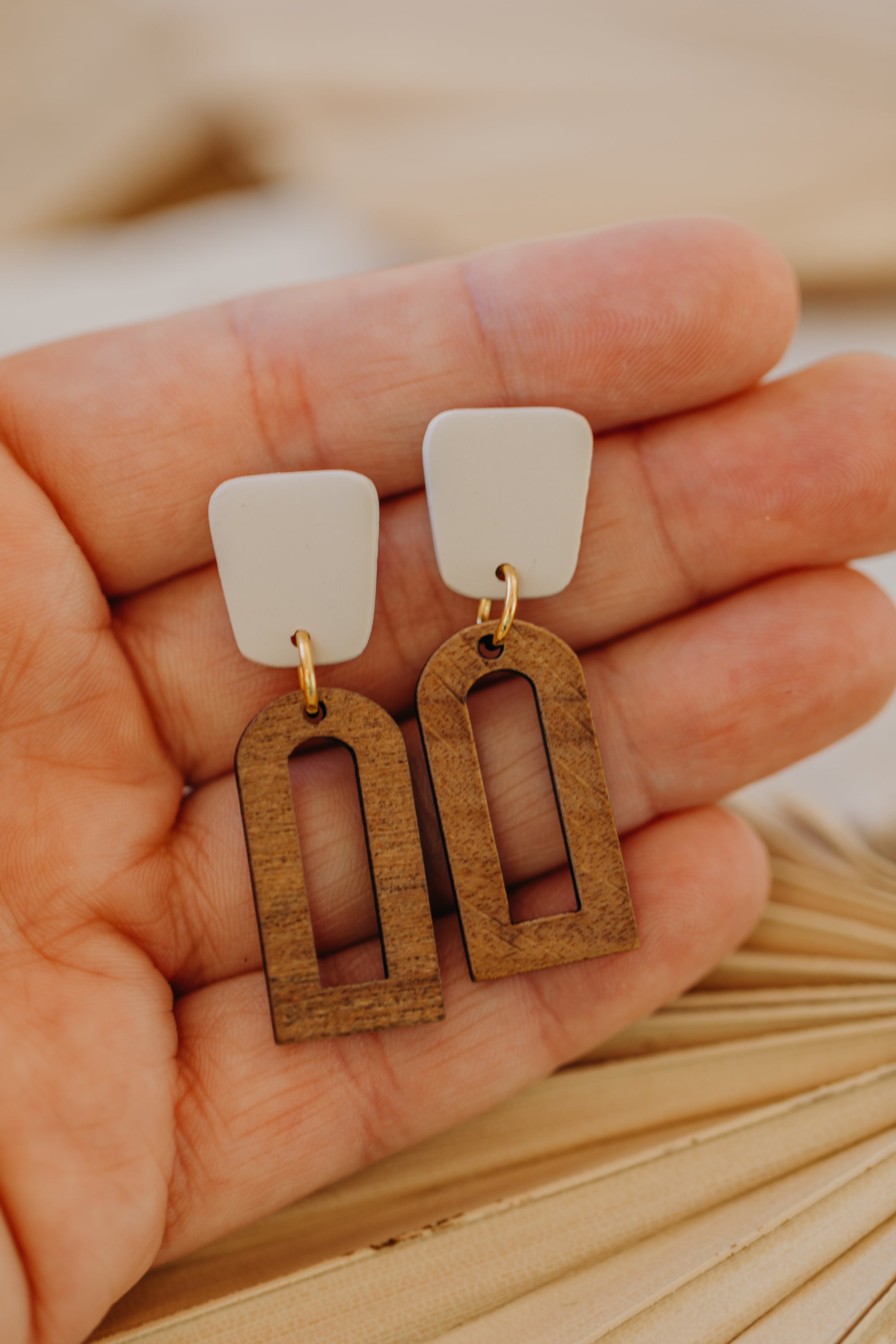 triangular polymer clay earrings in eucalyptus green with rectangular wooden pendant