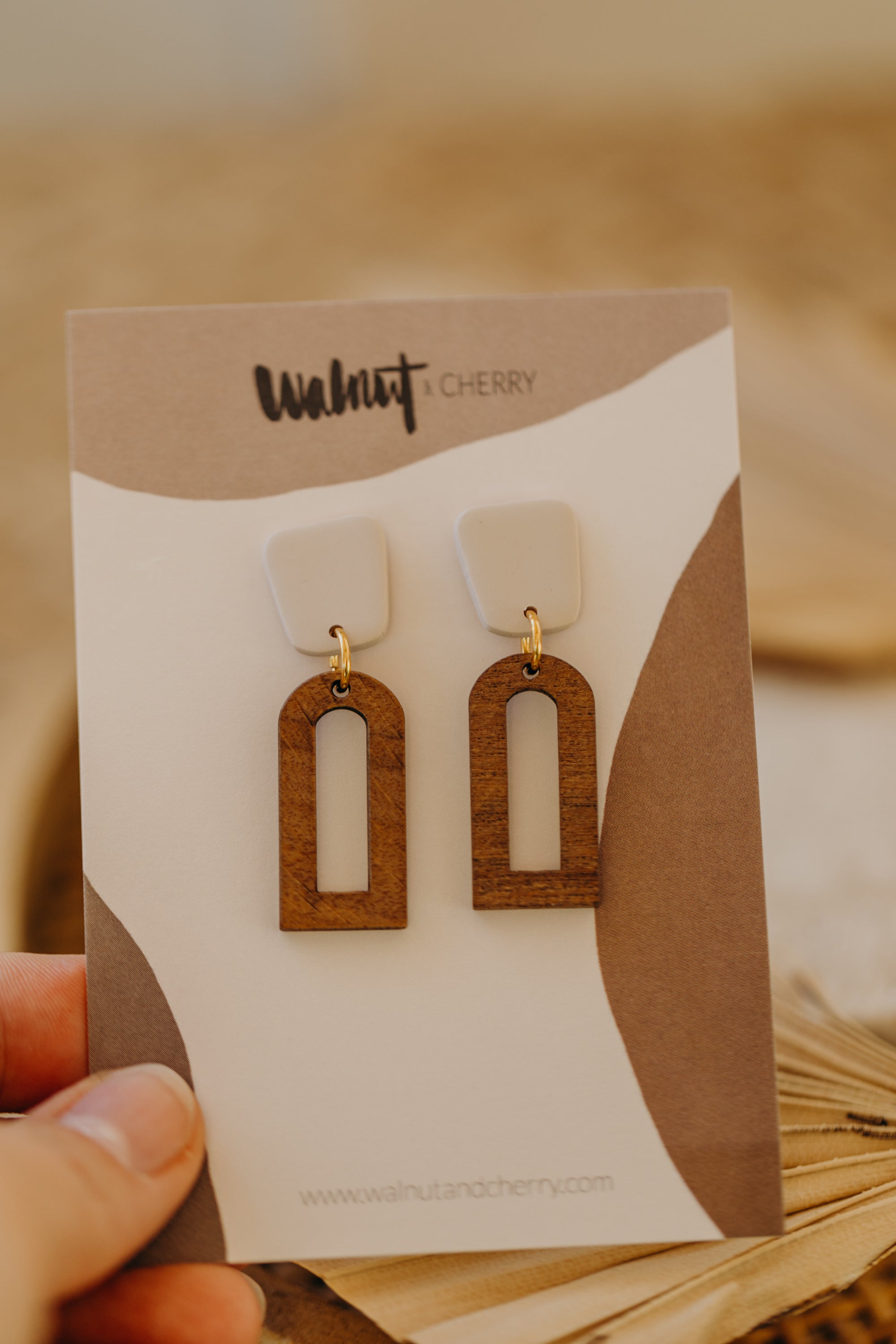 triangular polymer clay earrings in eucalyptus green with rectangular wooden pendant