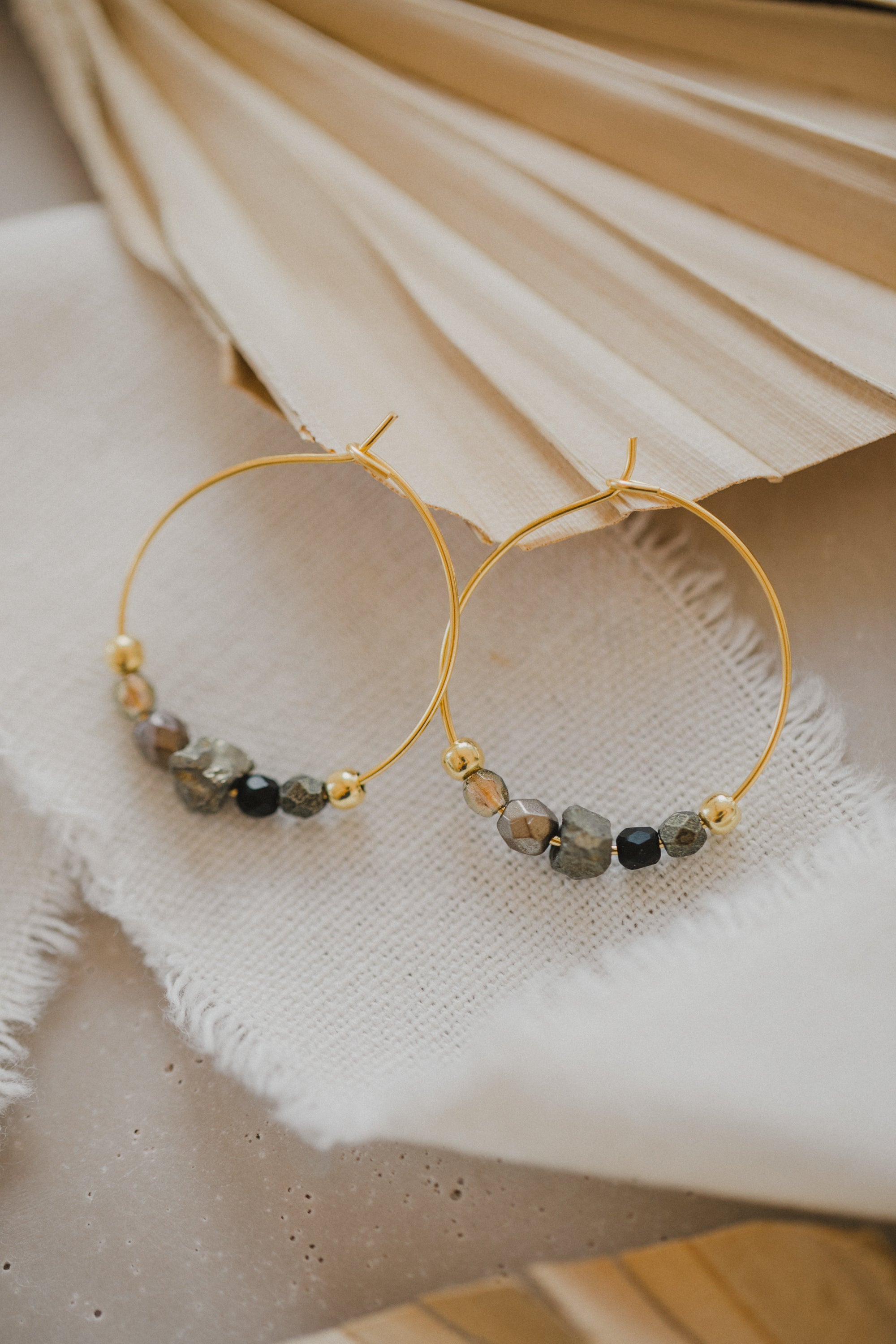 filigree creole made of titanium with pyrite gemstones