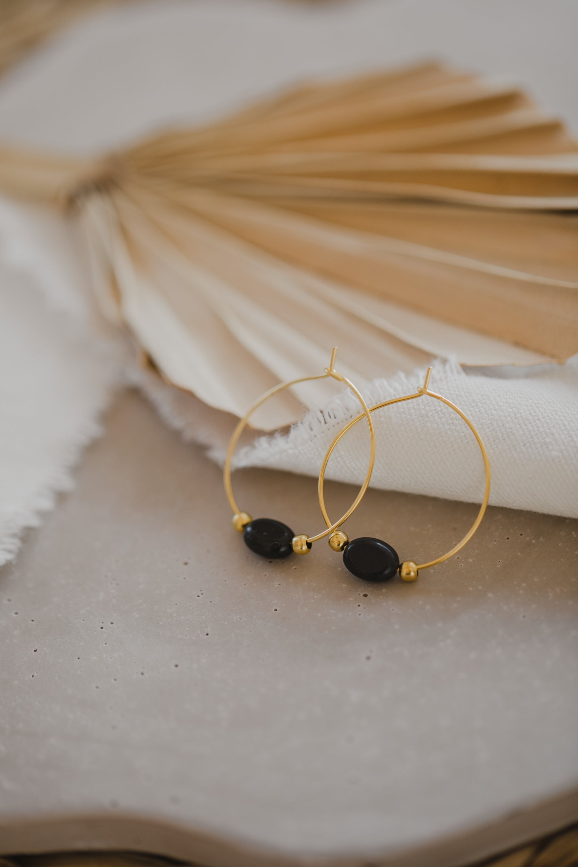 filigree creole made of titanium with oval black obsidian gemstone