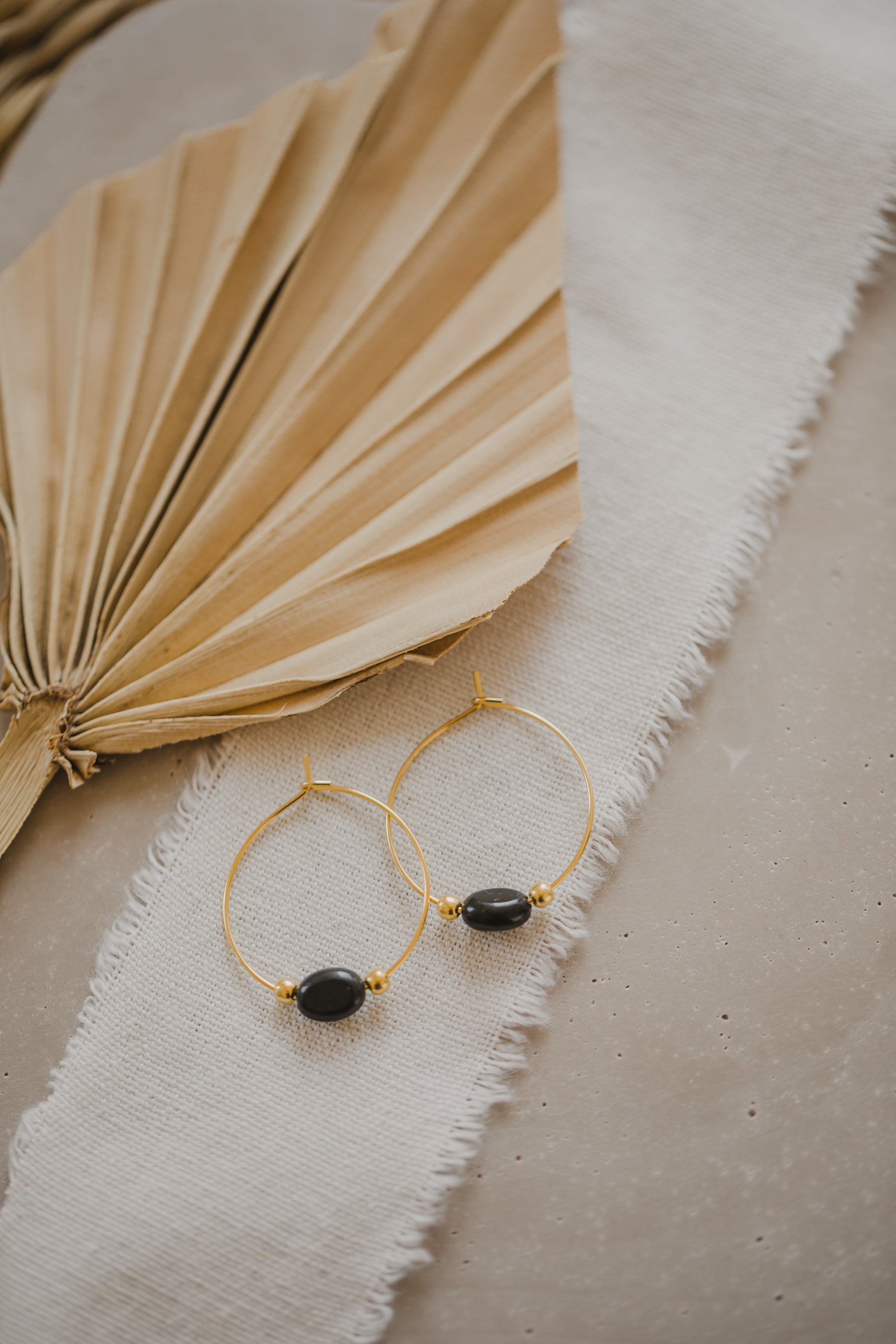 filigree creole made of titanium with oval black obsidian gemstone