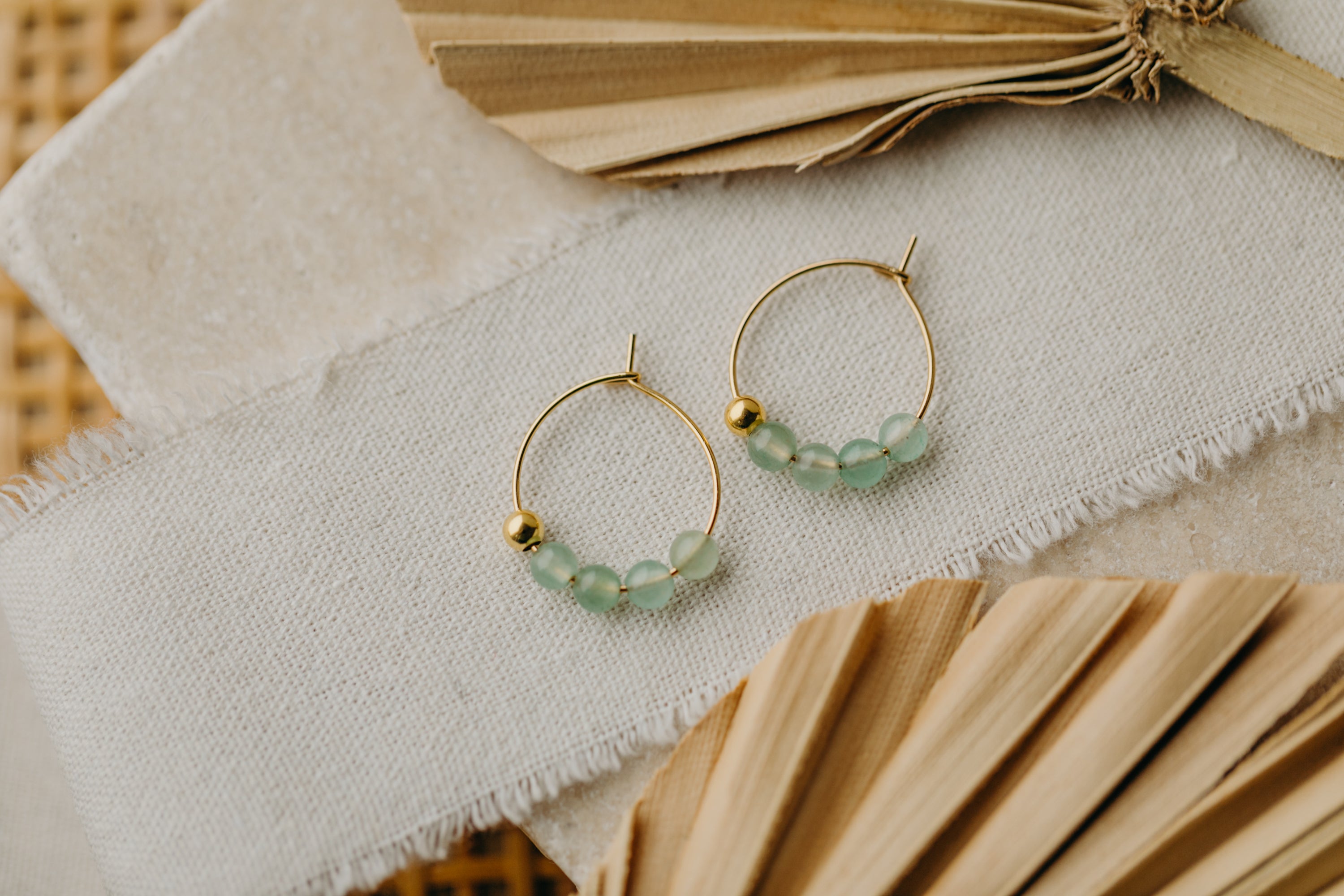 filigree creole made of titanium with green aventurine beads