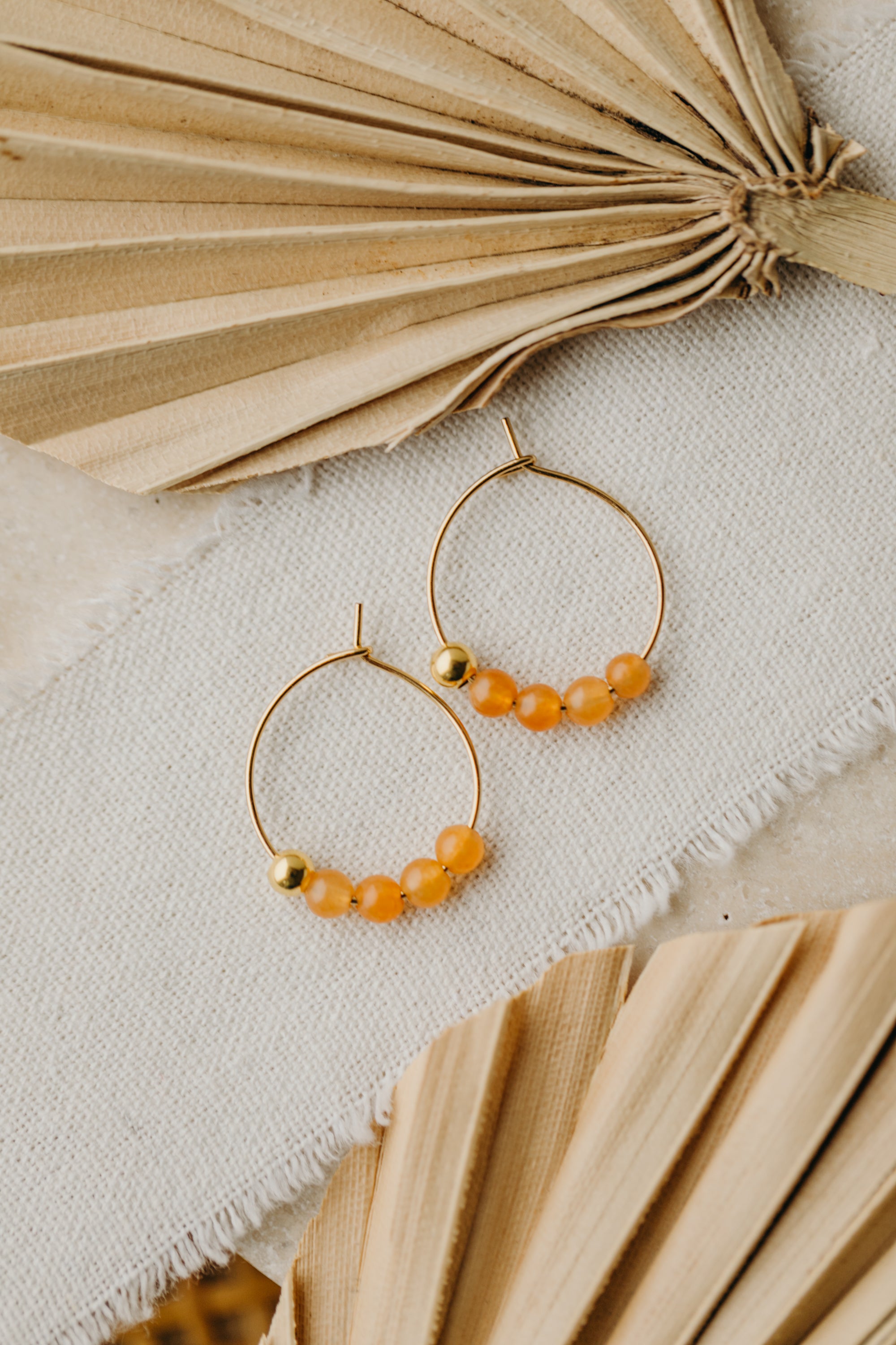 filigree creole made of titanium with orange aventurine beads