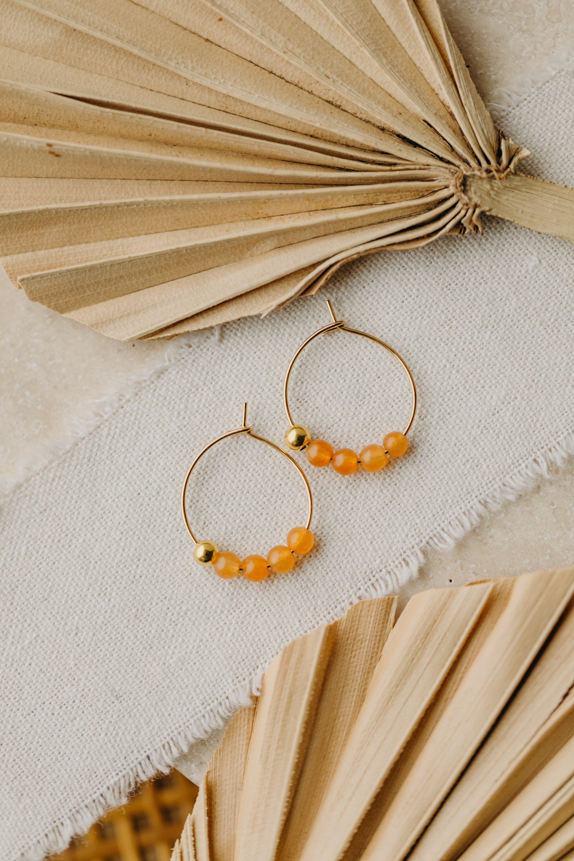 filigree creole made of titanium with orange aventurine beads