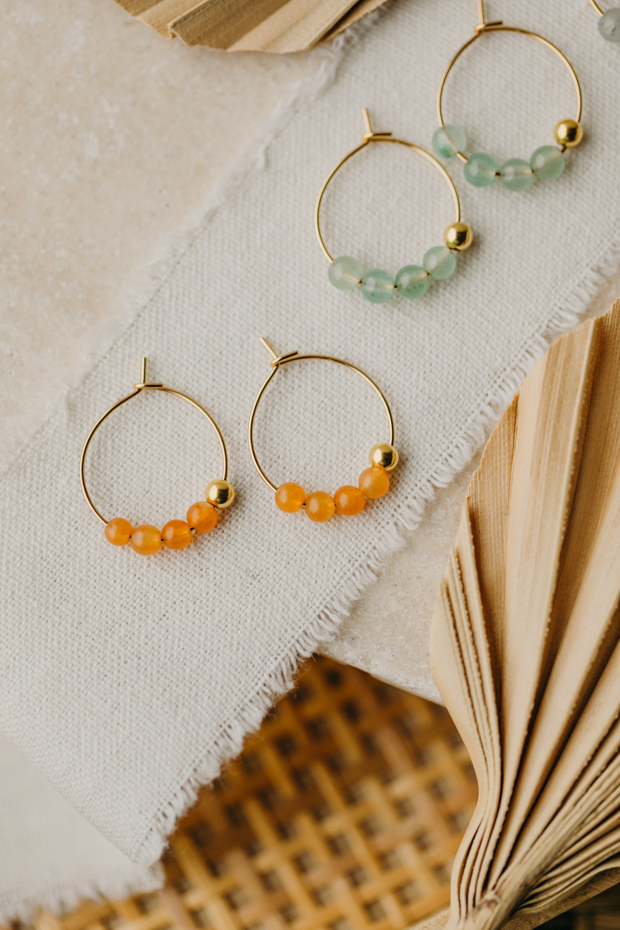 filigree creole made of titanium with orange aventurine beads