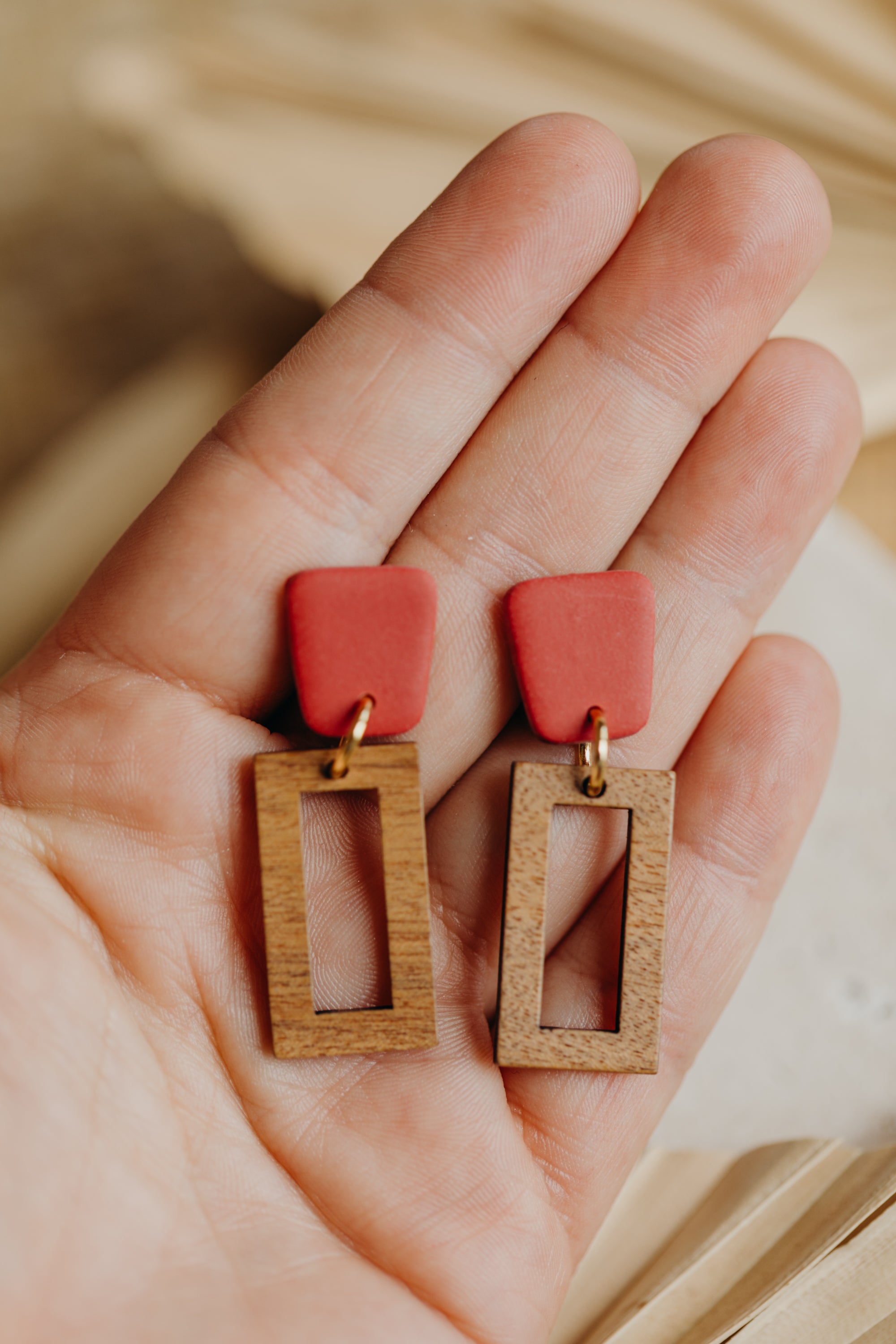 triangular polymer clay earrings in eucalyptus green with rectangular wooden pendant