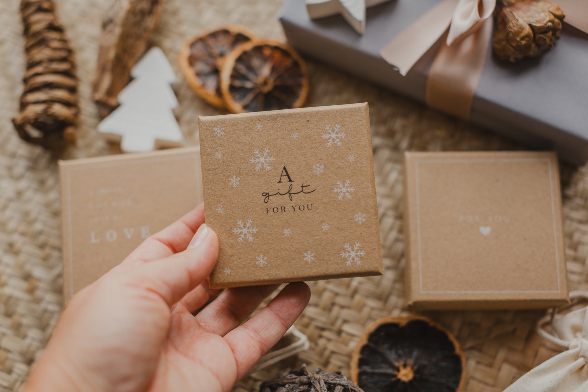 Gift box kraft paper with print "A gift for you" and white snowflakes