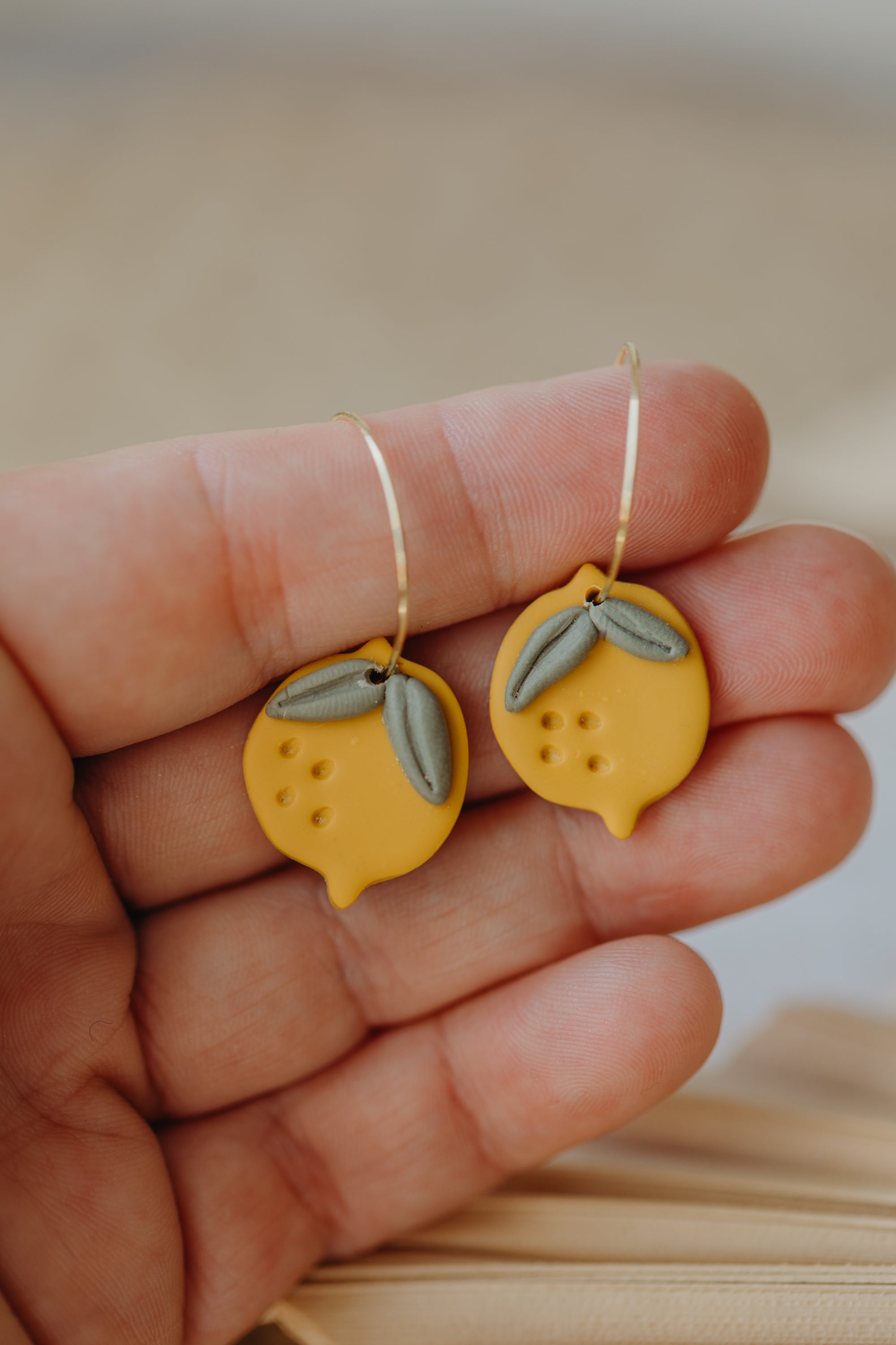 Hoop earrings with round polymer clay pendant and leaf