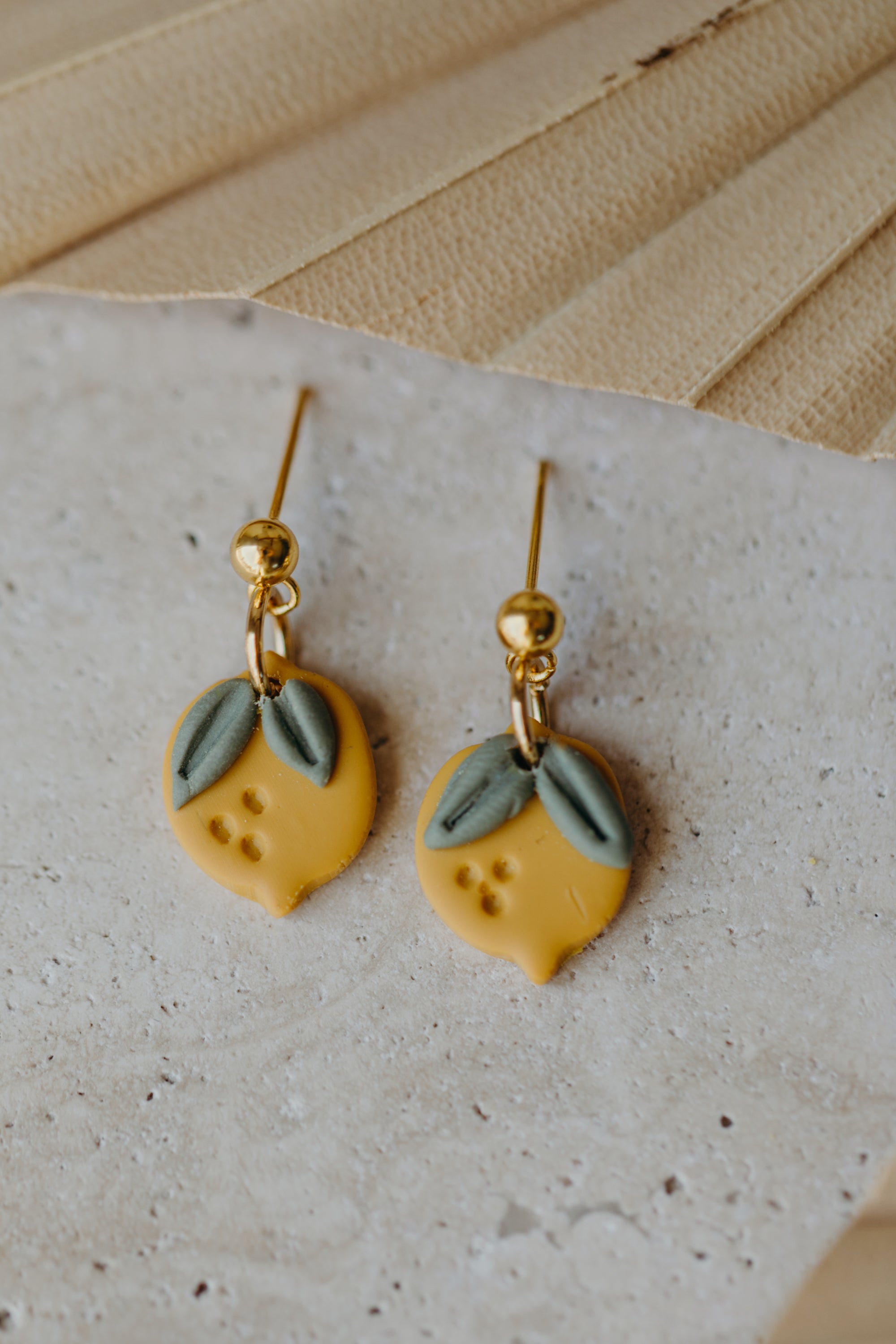 Hoop earrings with round polymer clay pendant and leaf