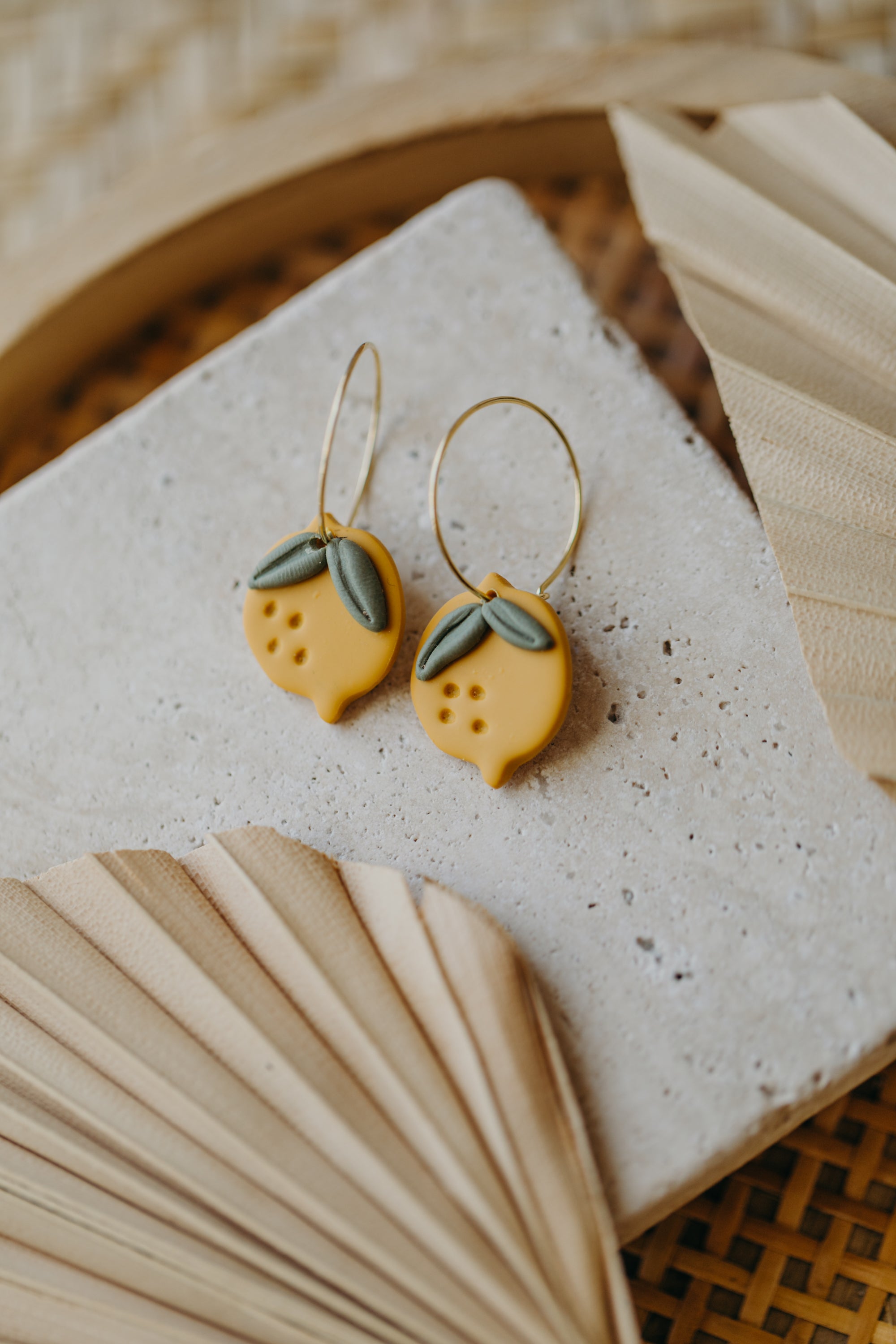 Hoop earrings with round polymer clay pendant and leaf