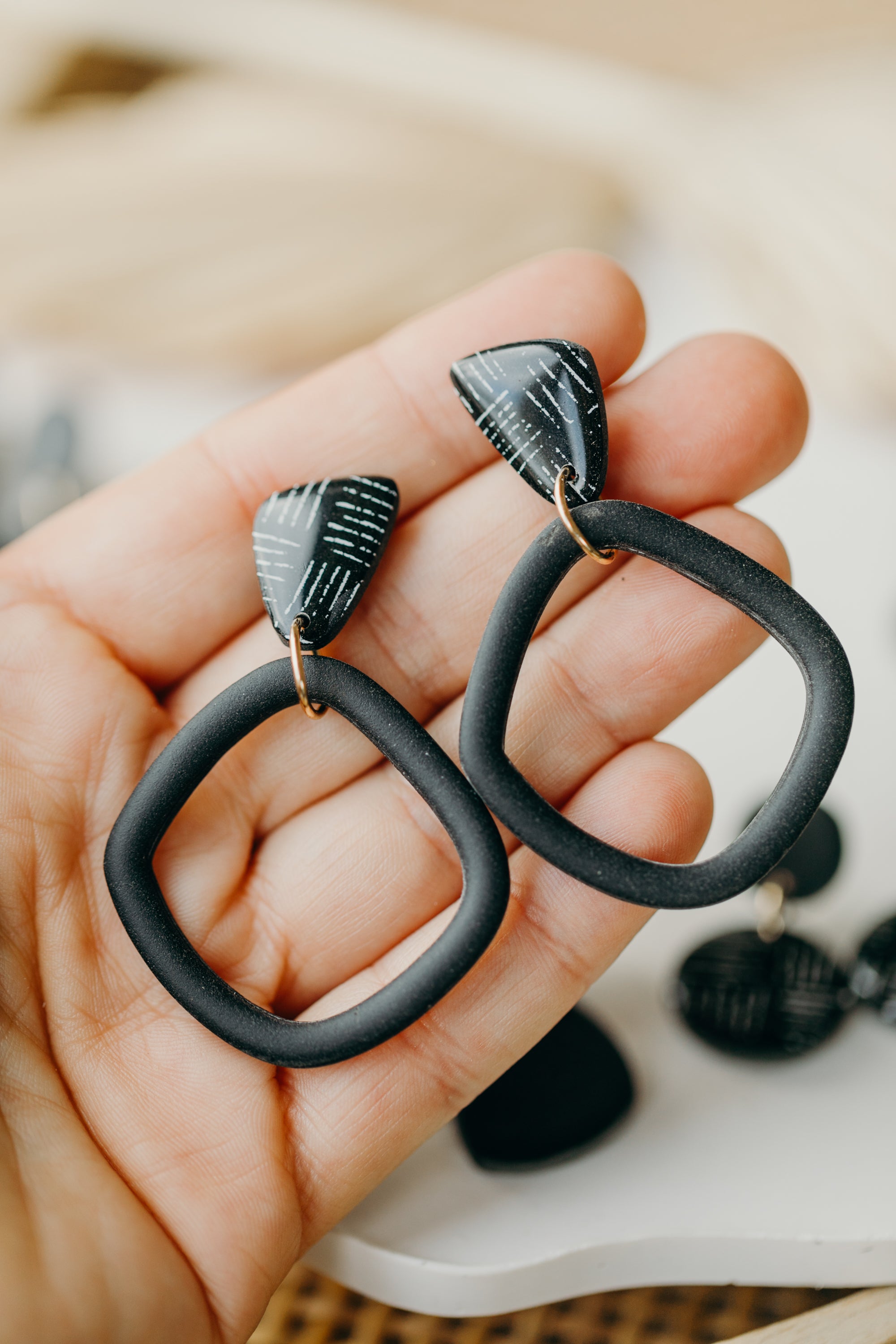 black polymer clay earrings with white pattern