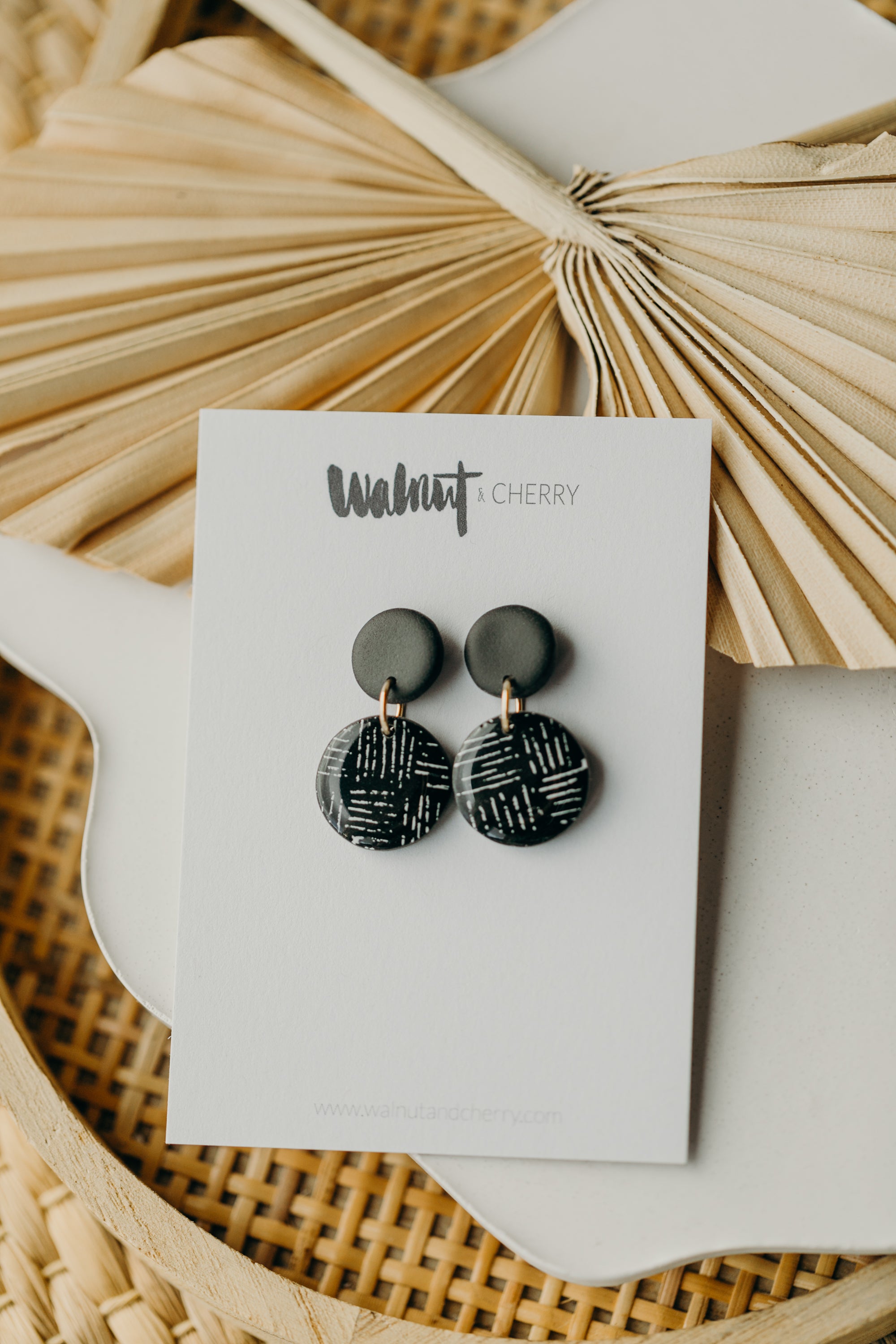 black polymer clay earrings with white pattern