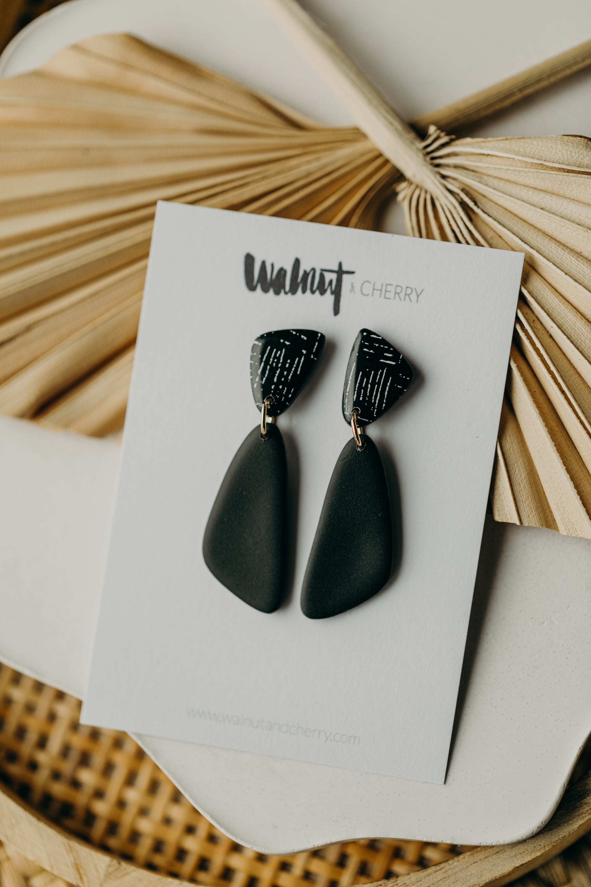 black polymer clay earrings with white pattern