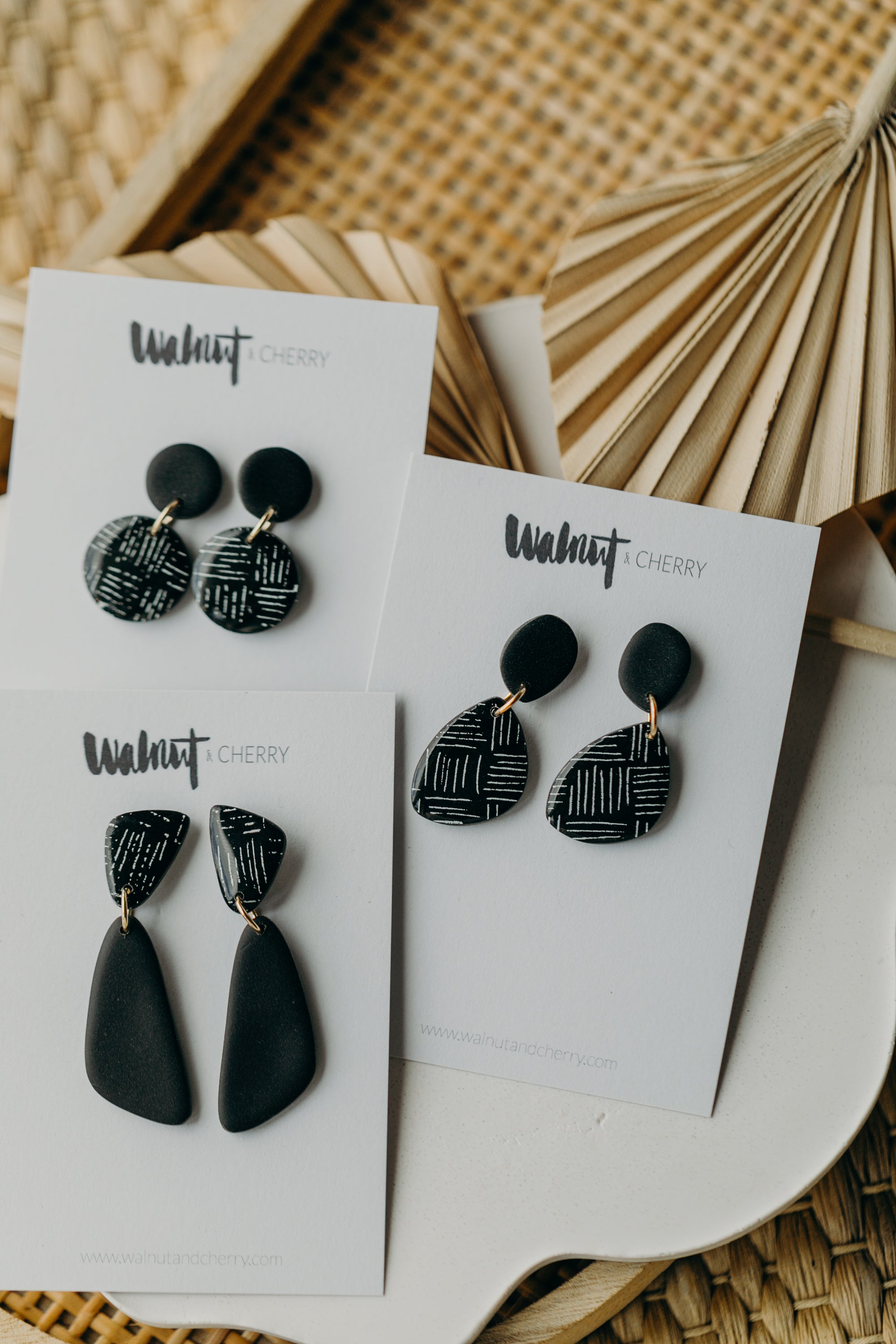 black polymer clay earrings with white pattern