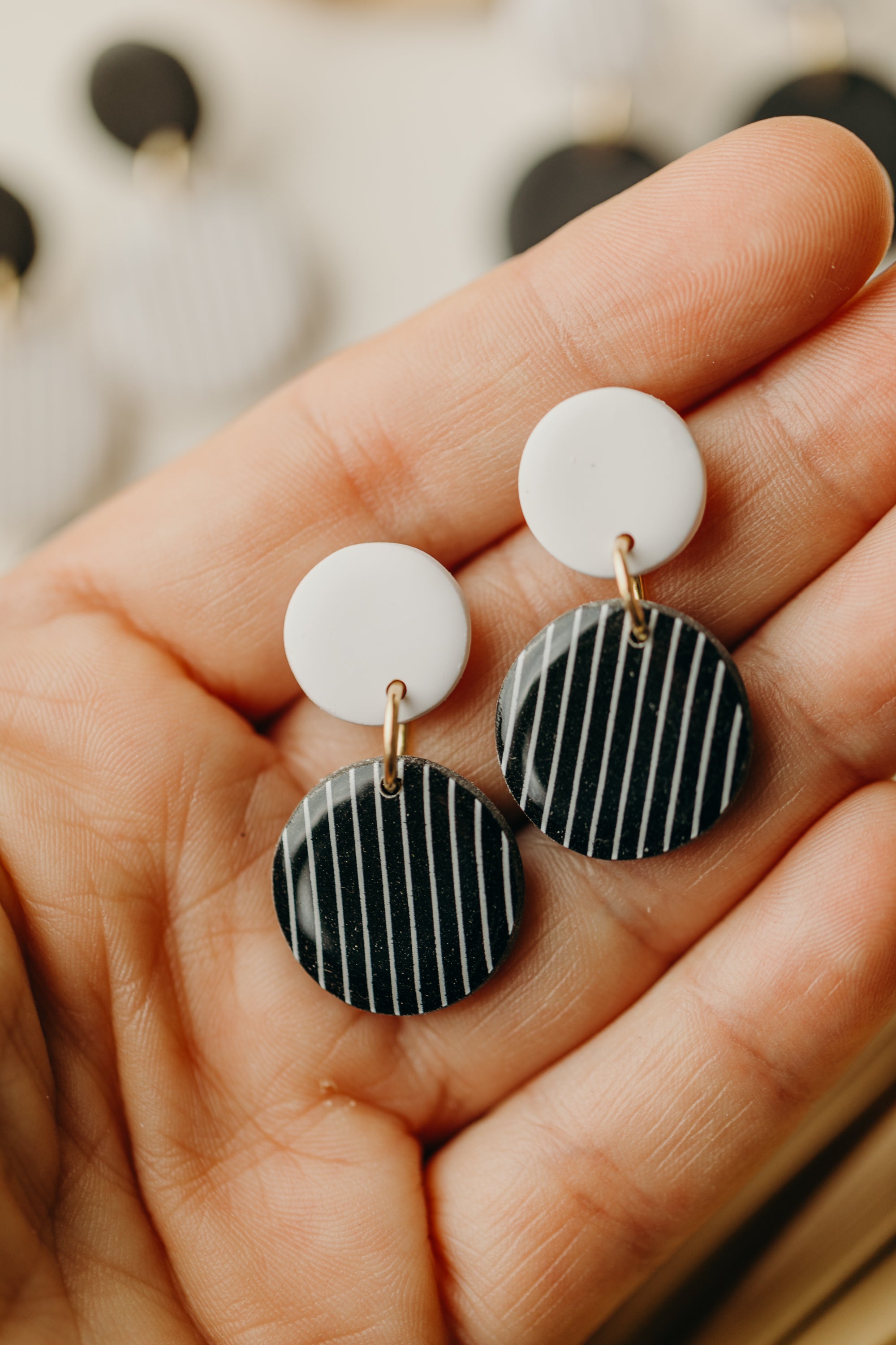 black and white round polymer clay earrings with stripes