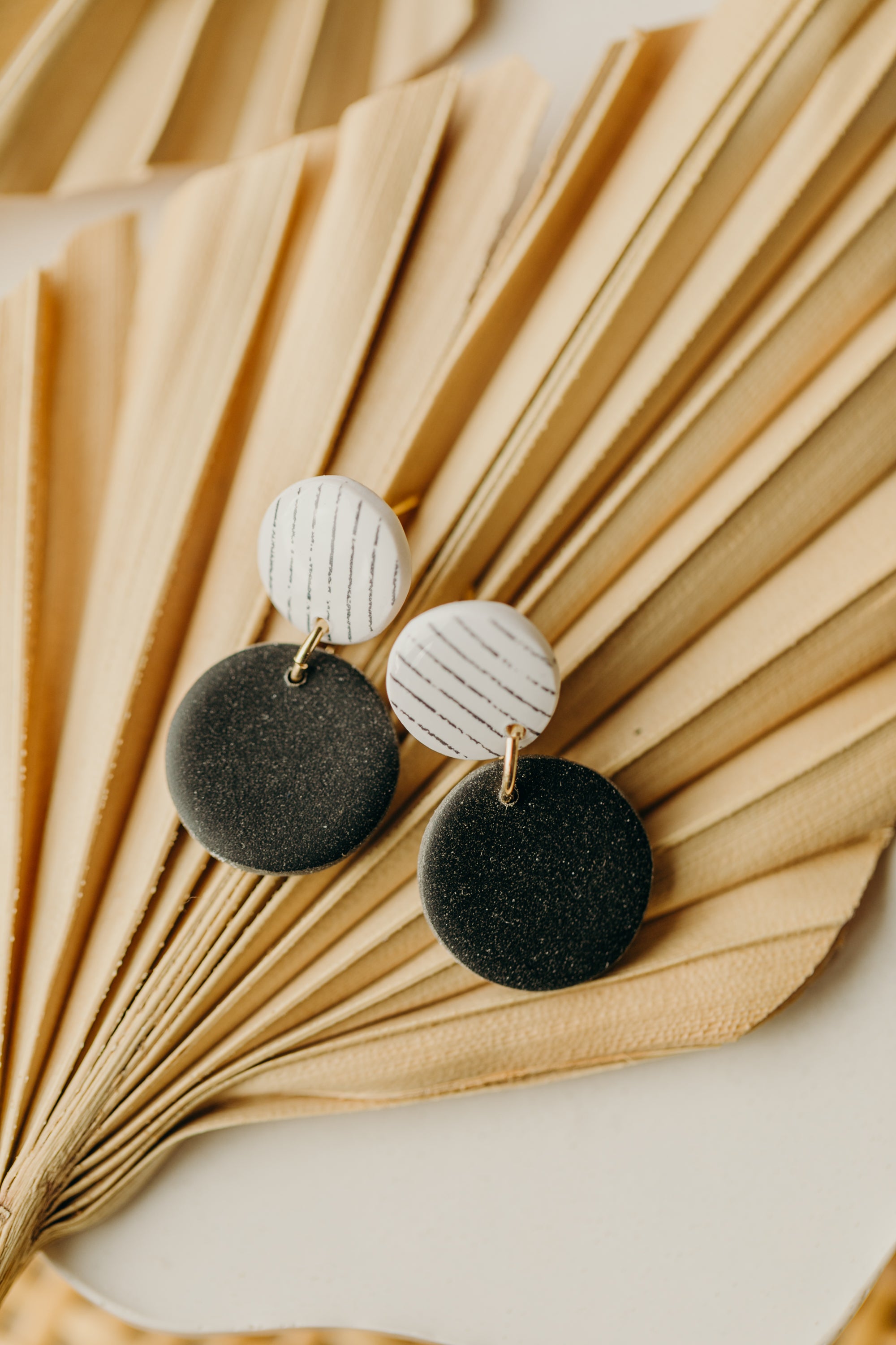 black and white round polymer clay earrings with stripes