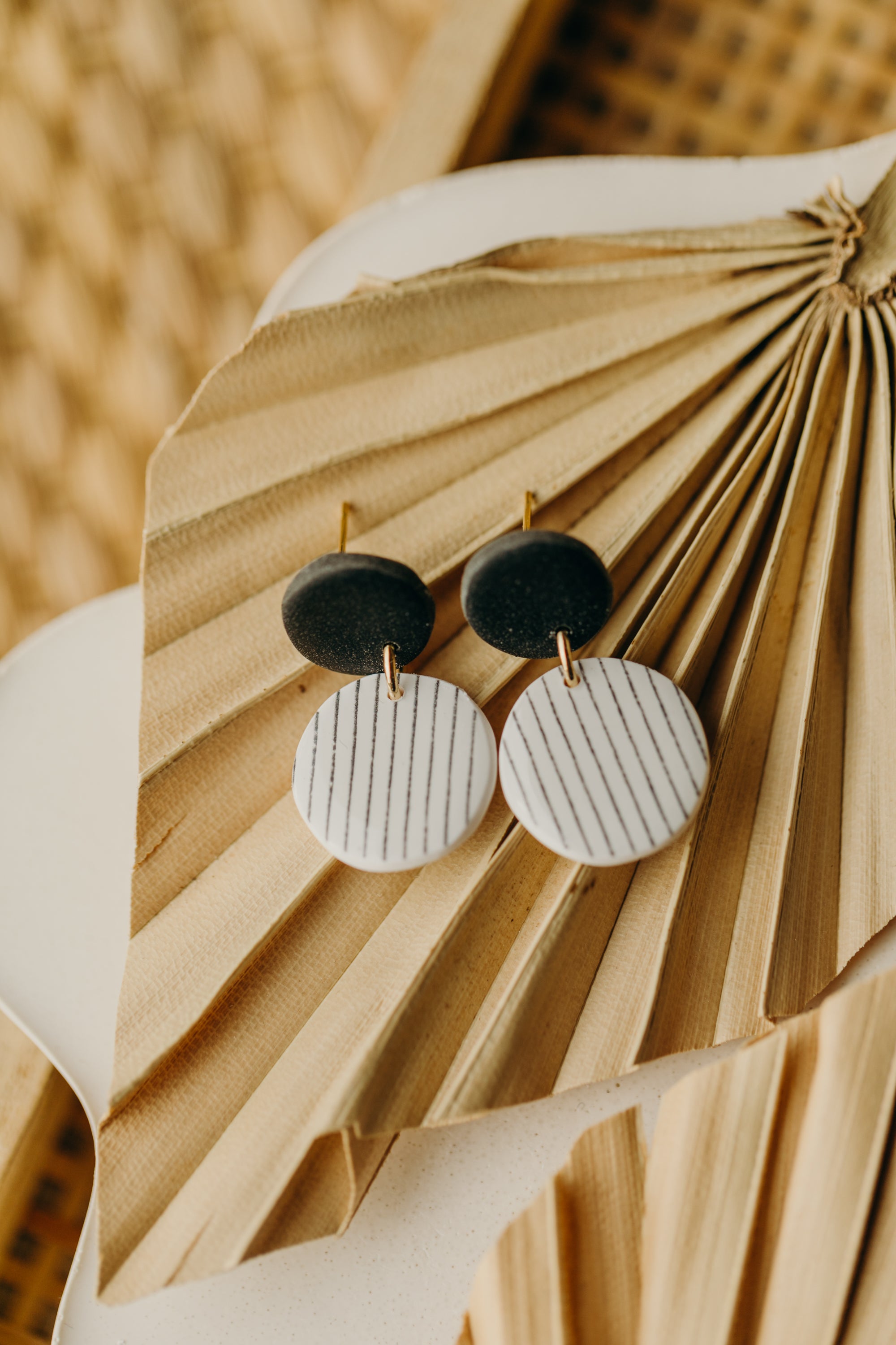 black and white round polymer clay earrings with stripes