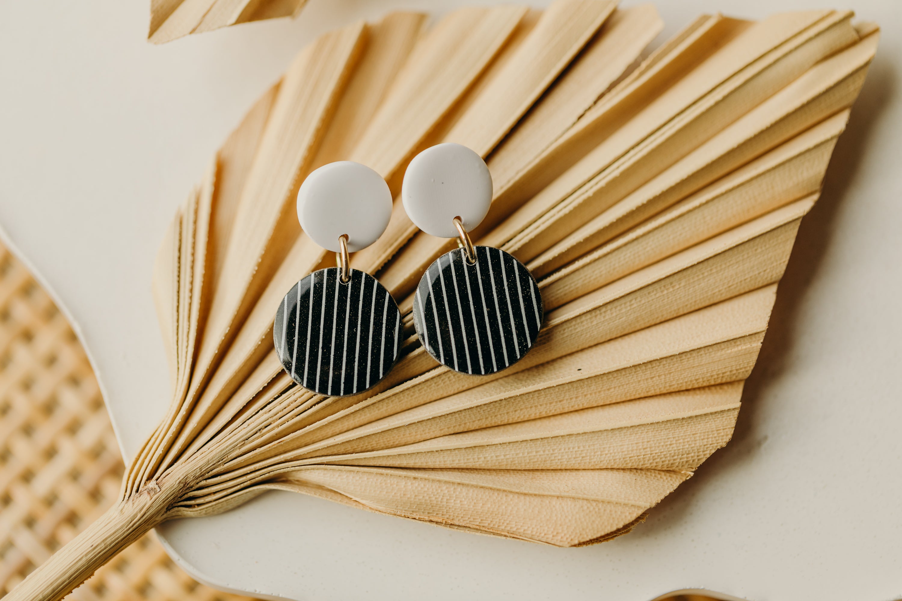 black and white round polymer clay earrings with stripes