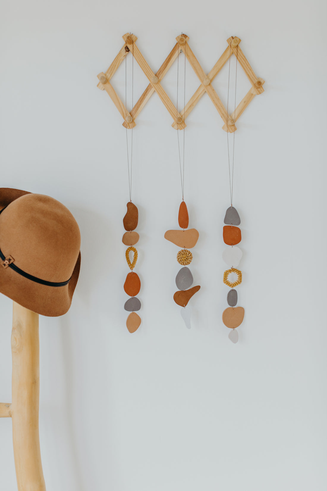 Wall decoration made of polymer clay in natural colors and rattan elements