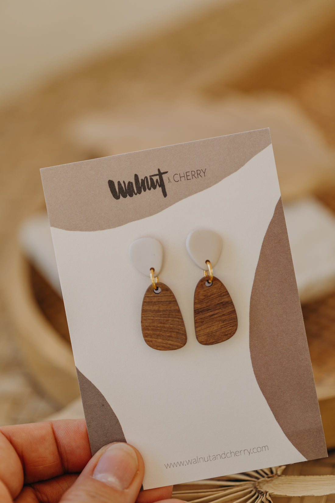 triangular polymer clay earrings in eucalyptus green with rectangular wooden pendant