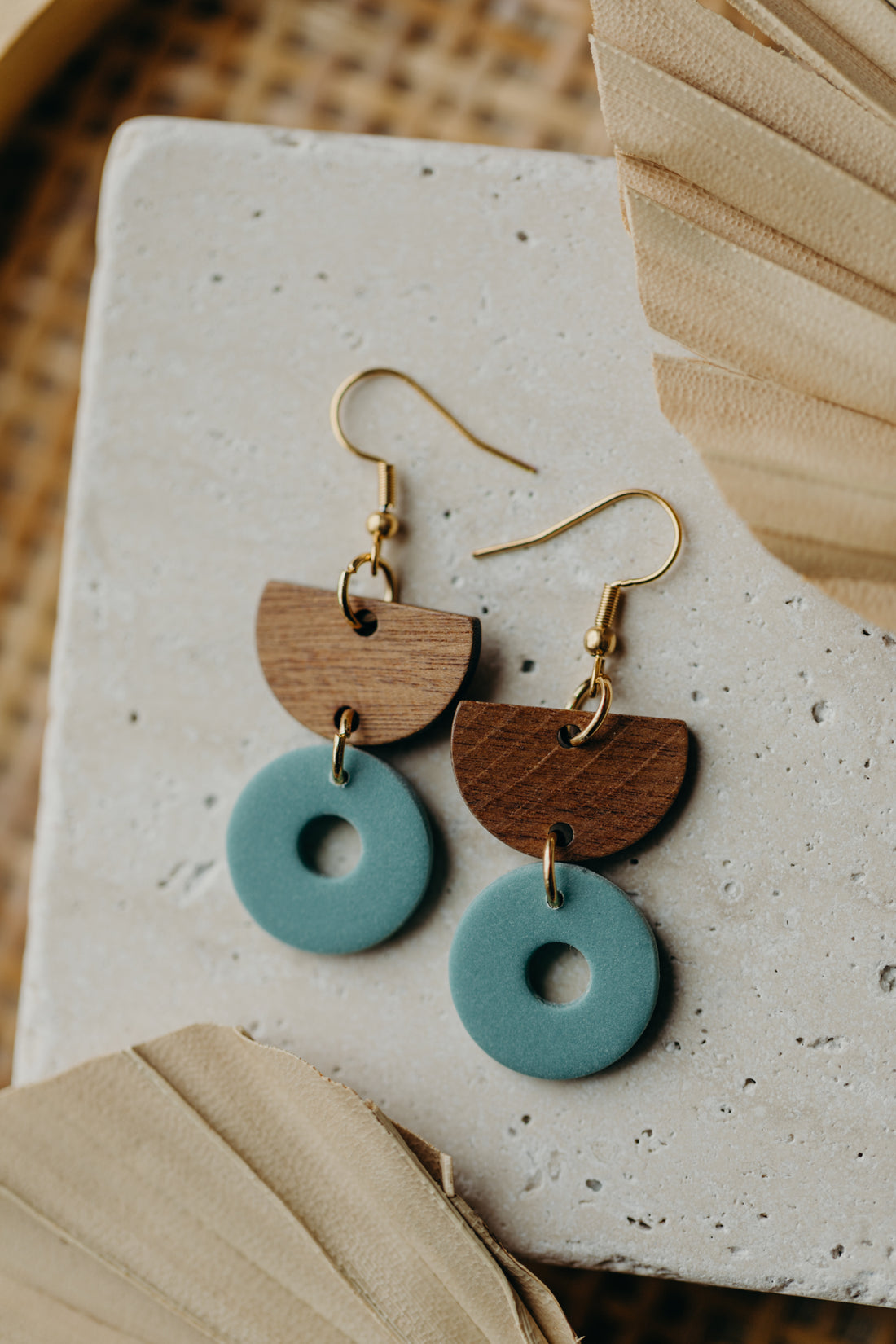 triangular polymer clay earrings in eucalyptus green with rectangular wooden pendant