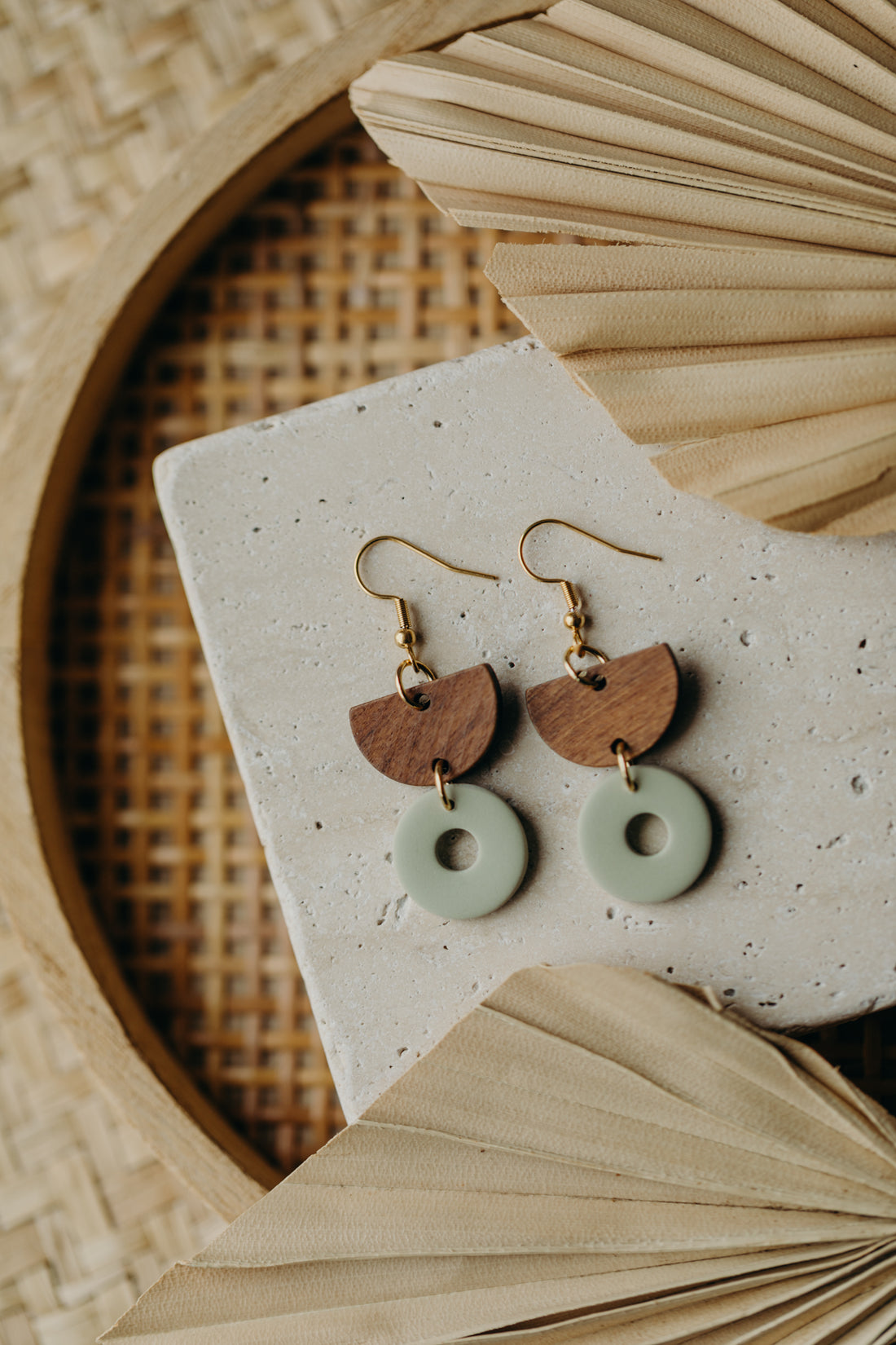 triangular polymer clay earrings in eucalyptus green with rectangular wooden pendant