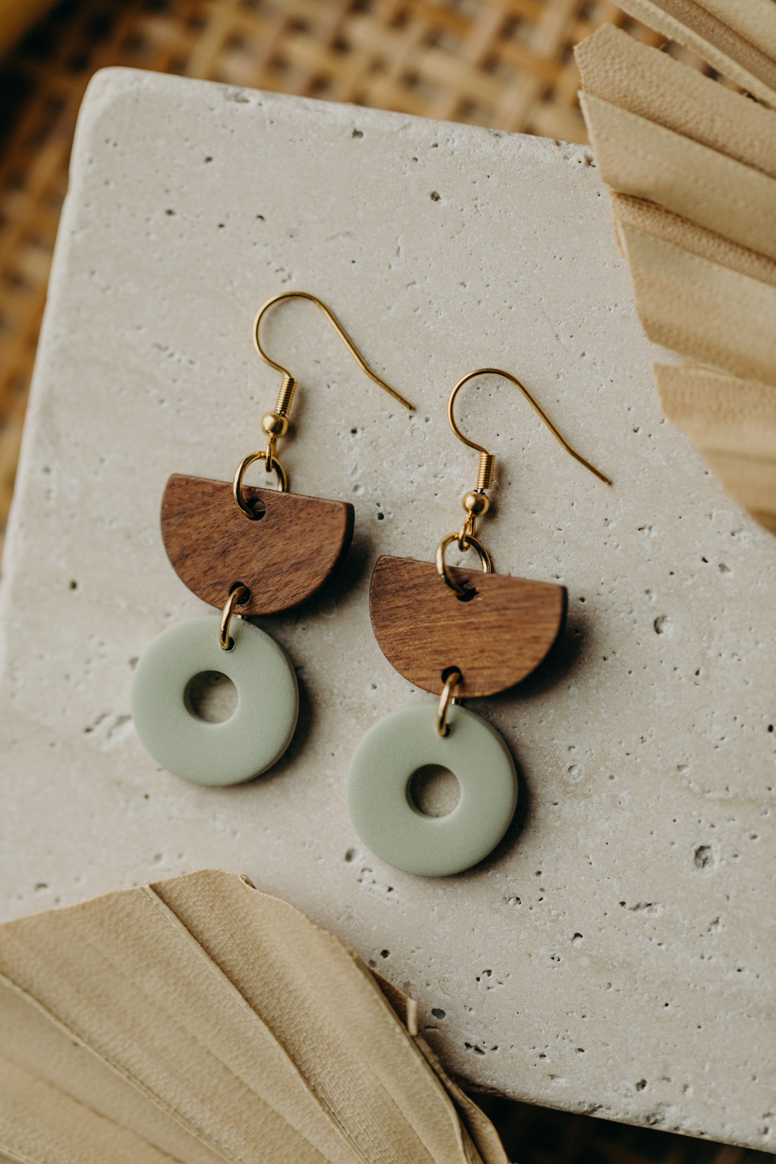 triangular polymer clay earrings in eucalyptus green with rectangular wooden pendant