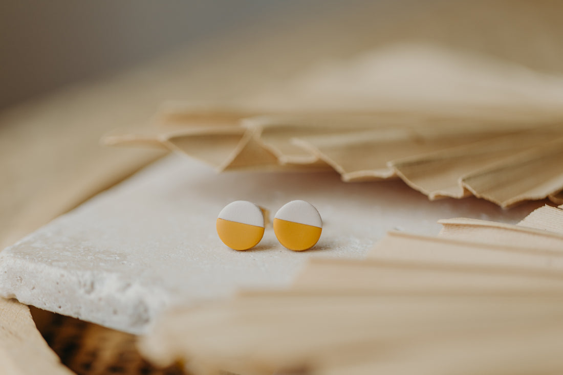 small round two-tone earrings made of polymer clay in pastel colors