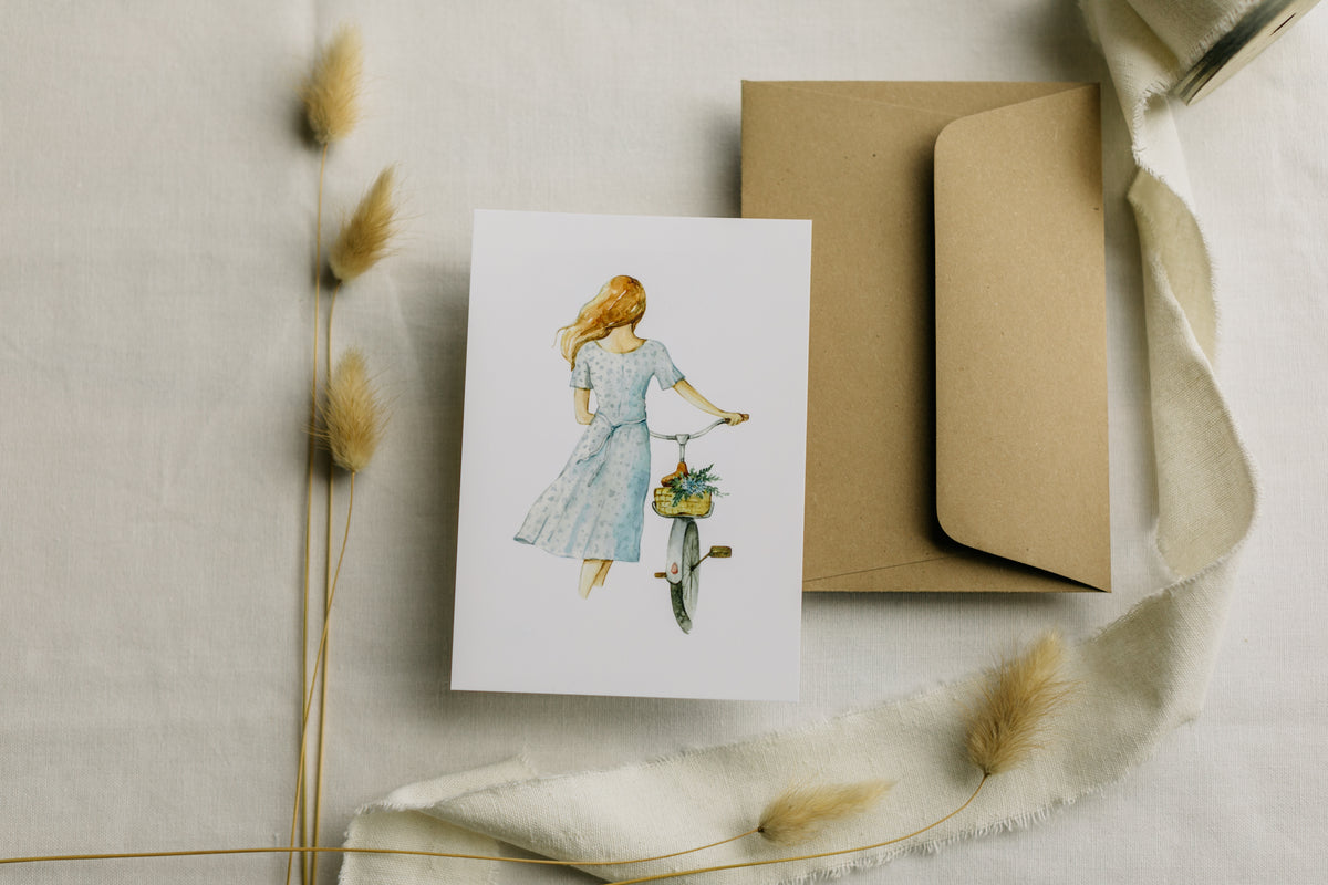 Postkarte Frau mit Fahrrad mit Blumen