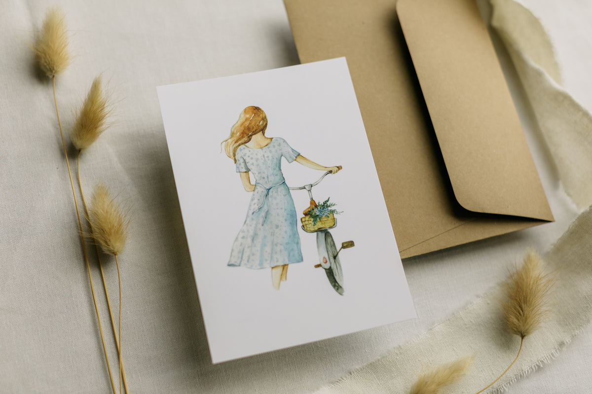 Postkarte Frau mit Fahrrad mit Blumen