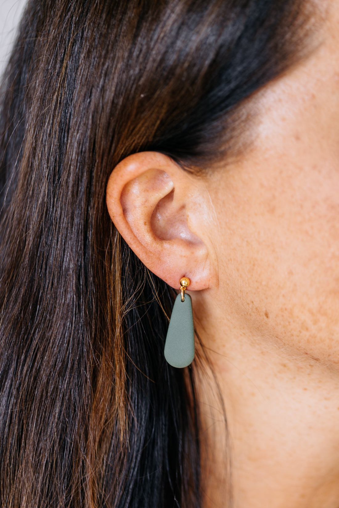 golden earrings with acrylic in white, petrol and brown