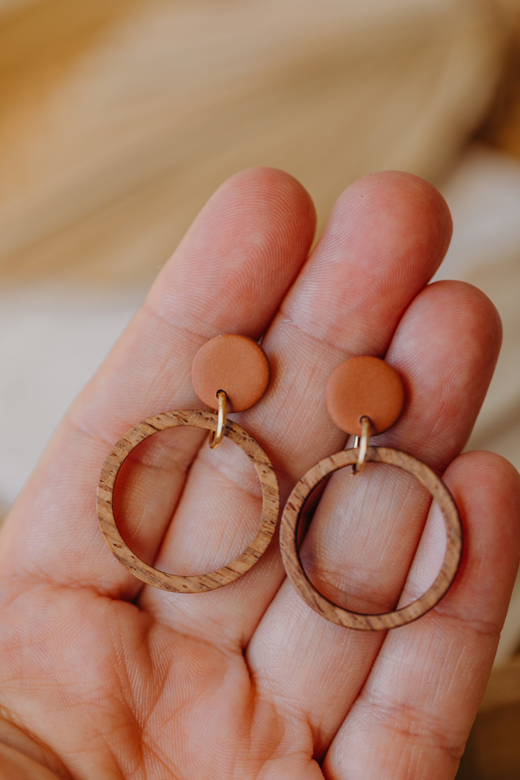 Cinnamon colored polymer clay earrings with wooden pendant circle