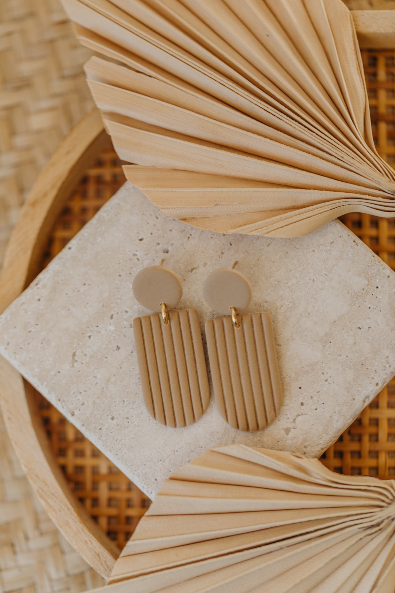 MOEMI - striped sand-colored earrings in a bow shape