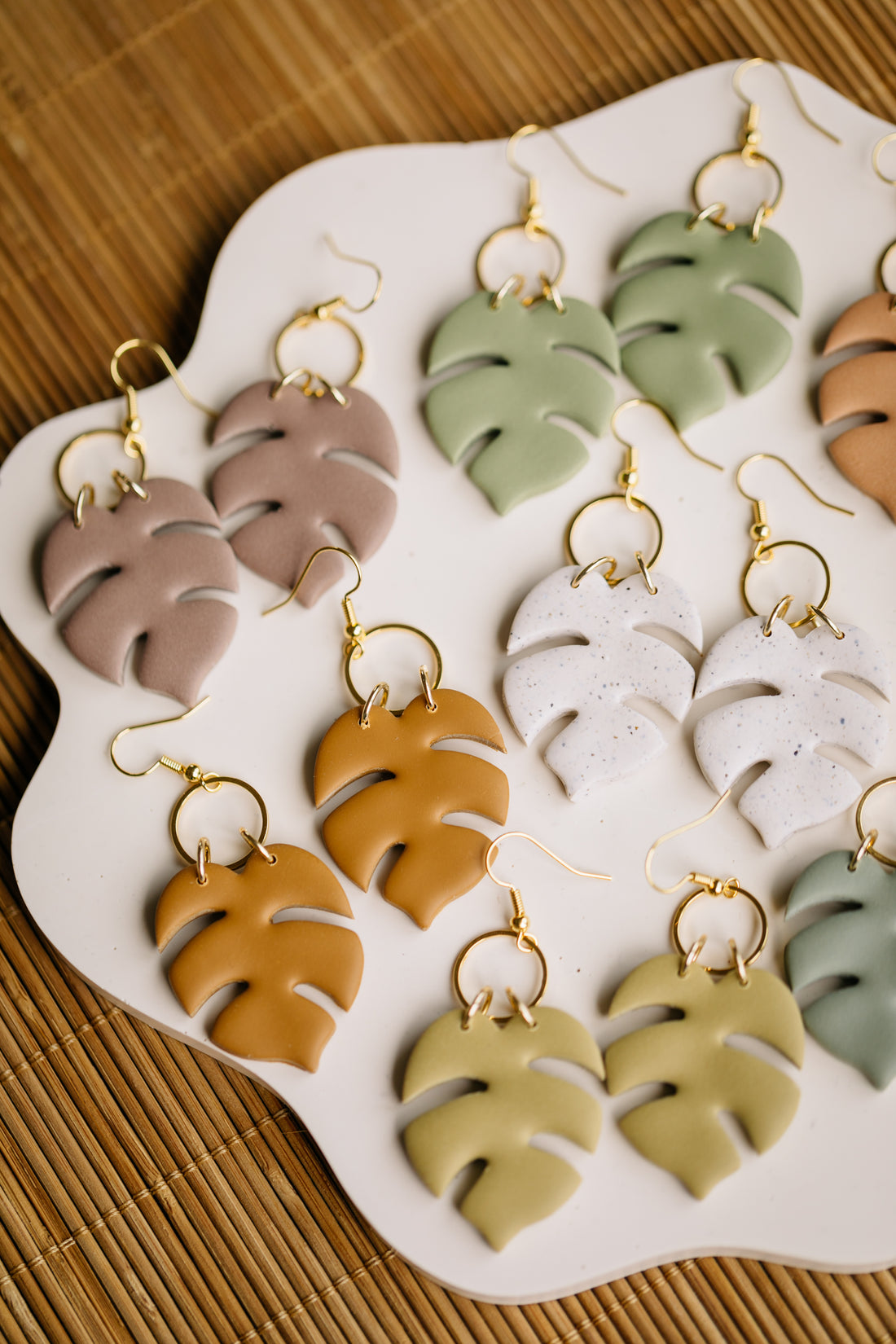 golden earrings with acrylic in white, petrol and brown