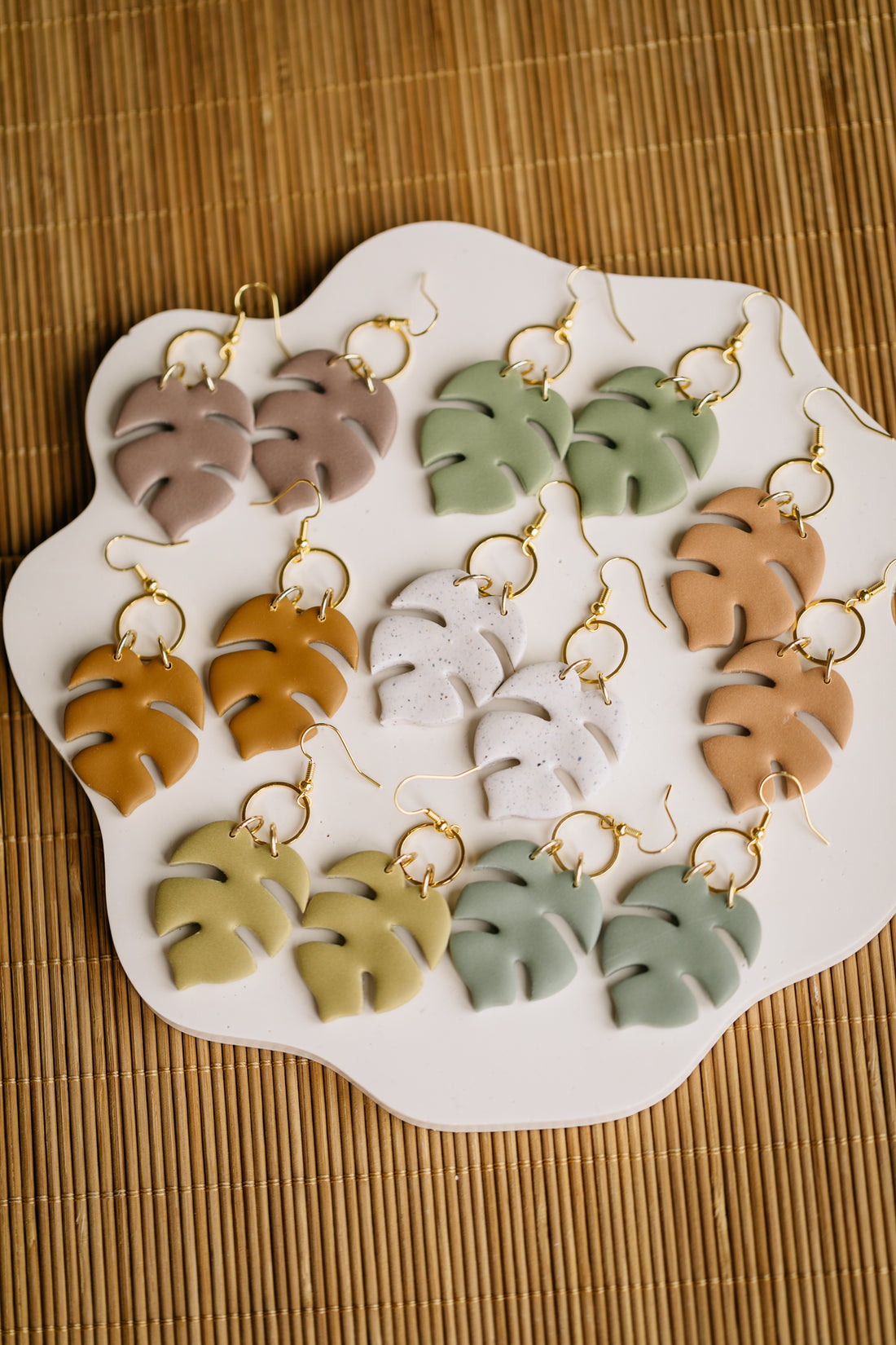 golden earrings with acrylic in white, petrol and brown
