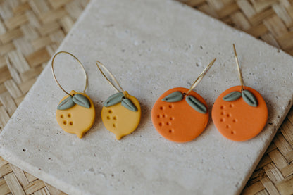 Hoop earrings with round polymer clay pendant and leaf