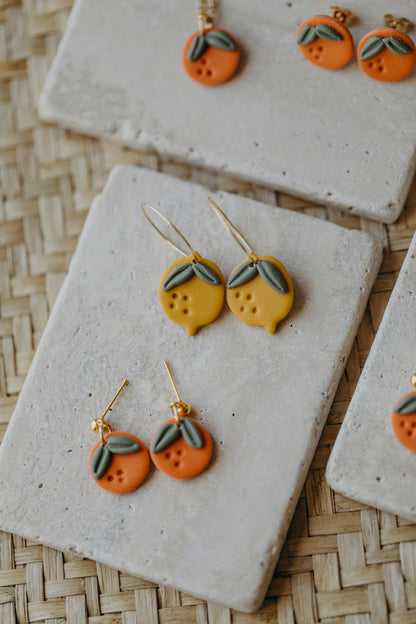 Hoop earrings with round polymer clay pendant and leaf