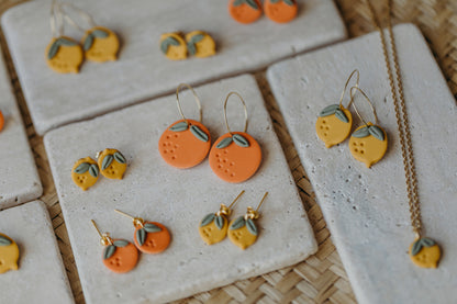 Hoop earrings with round polymer clay pendant and leaf