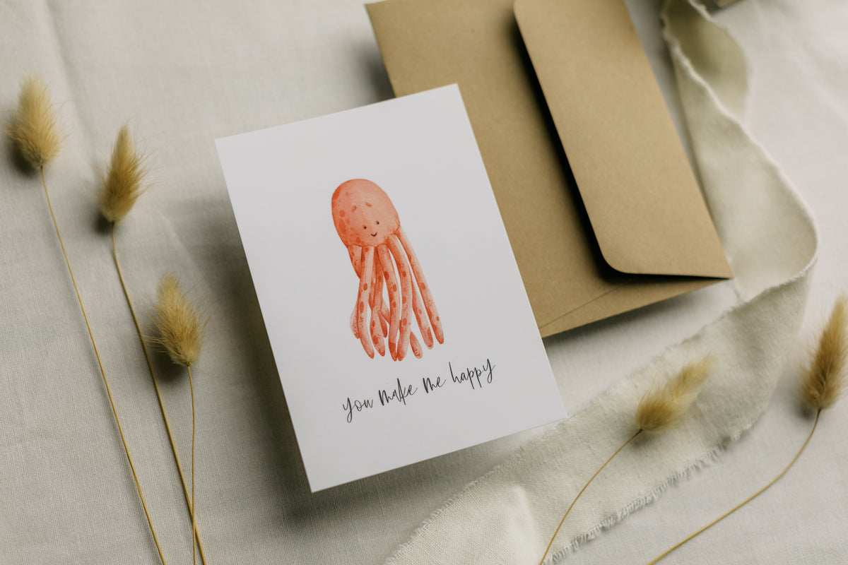 Postkarte roter Oktopus mit dem Aufdruck "you make me happy"