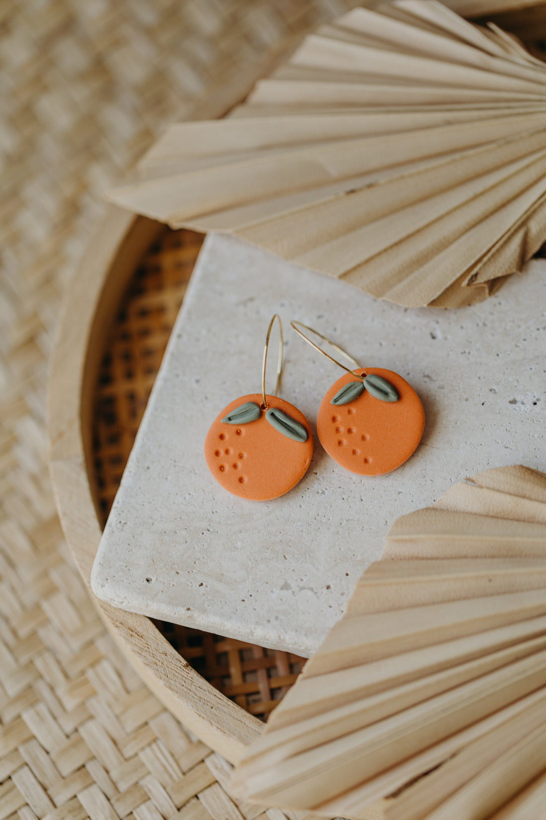 Hoop earrings with round polymer clay pendant and leaf