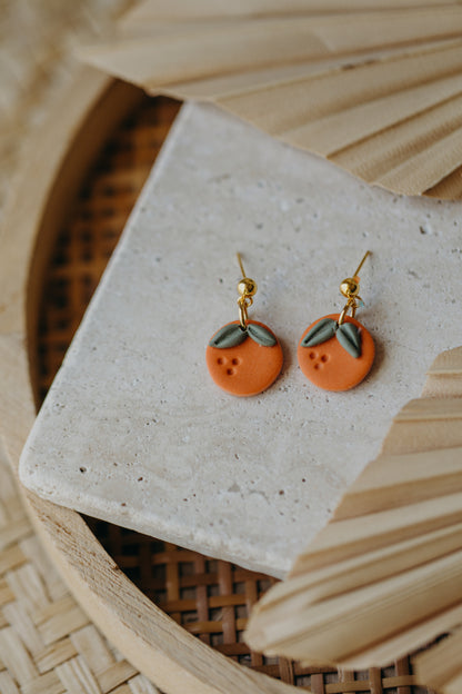 Hoop earrings with round polymer clay pendant and leaf