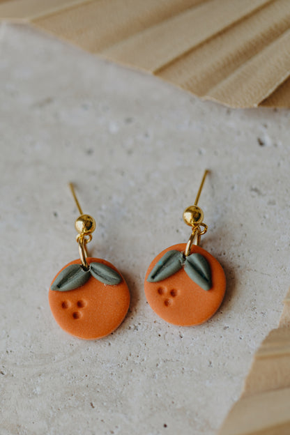 Hoop earrings with round polymer clay pendant and leaf