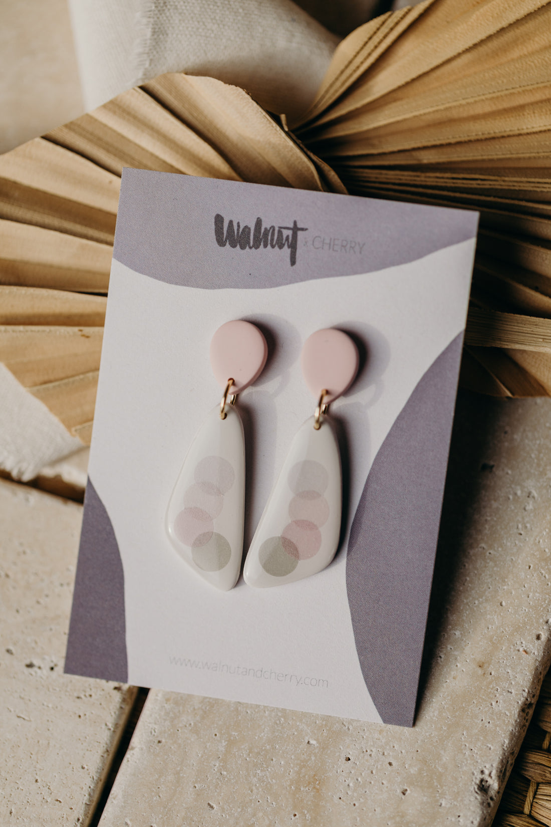elongated pink polymer clay earrings with pink and grey dots