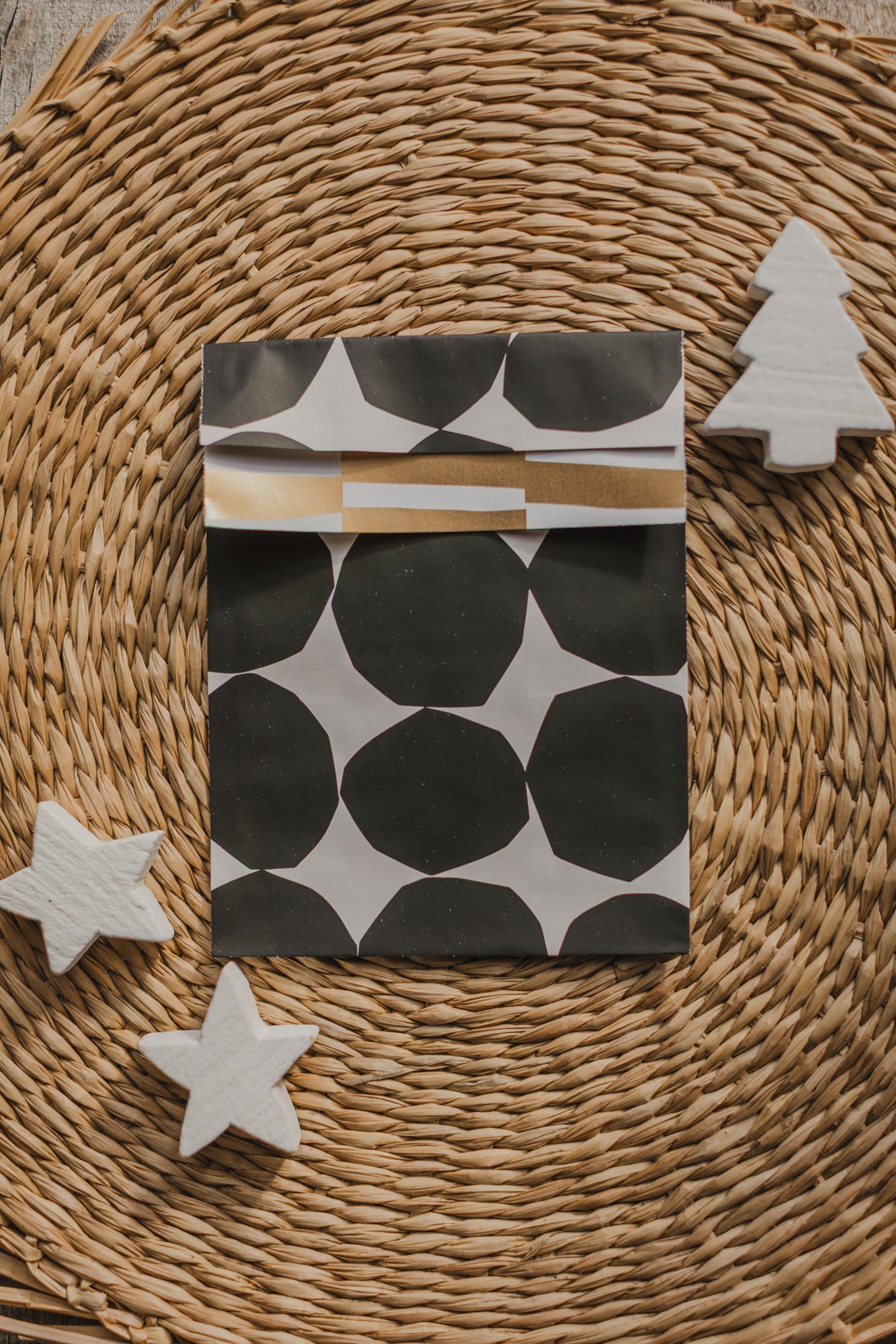 large paper bag with a small bird and branches