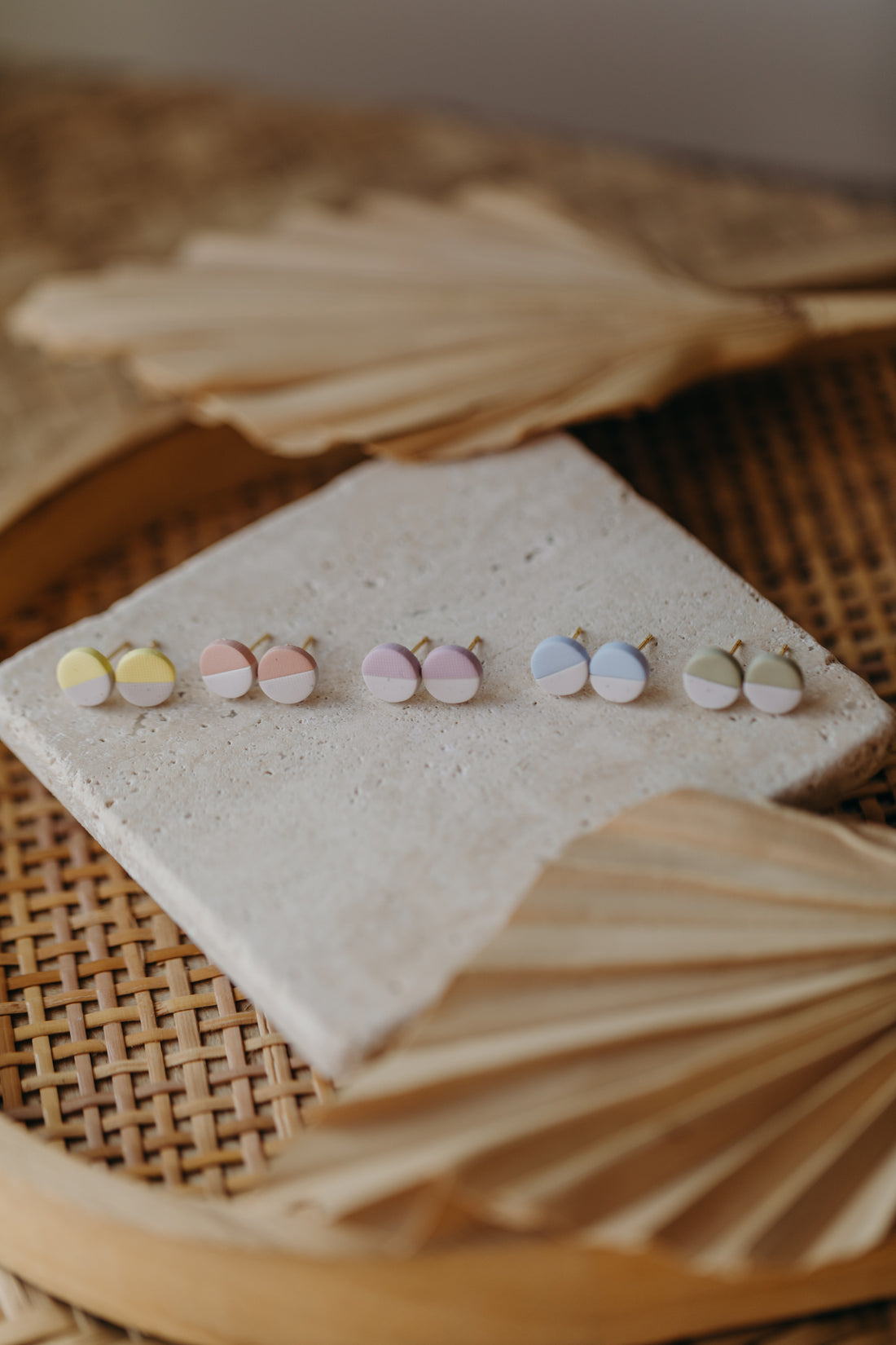 small round two-tone earrings made of polymer clay in pastel colors