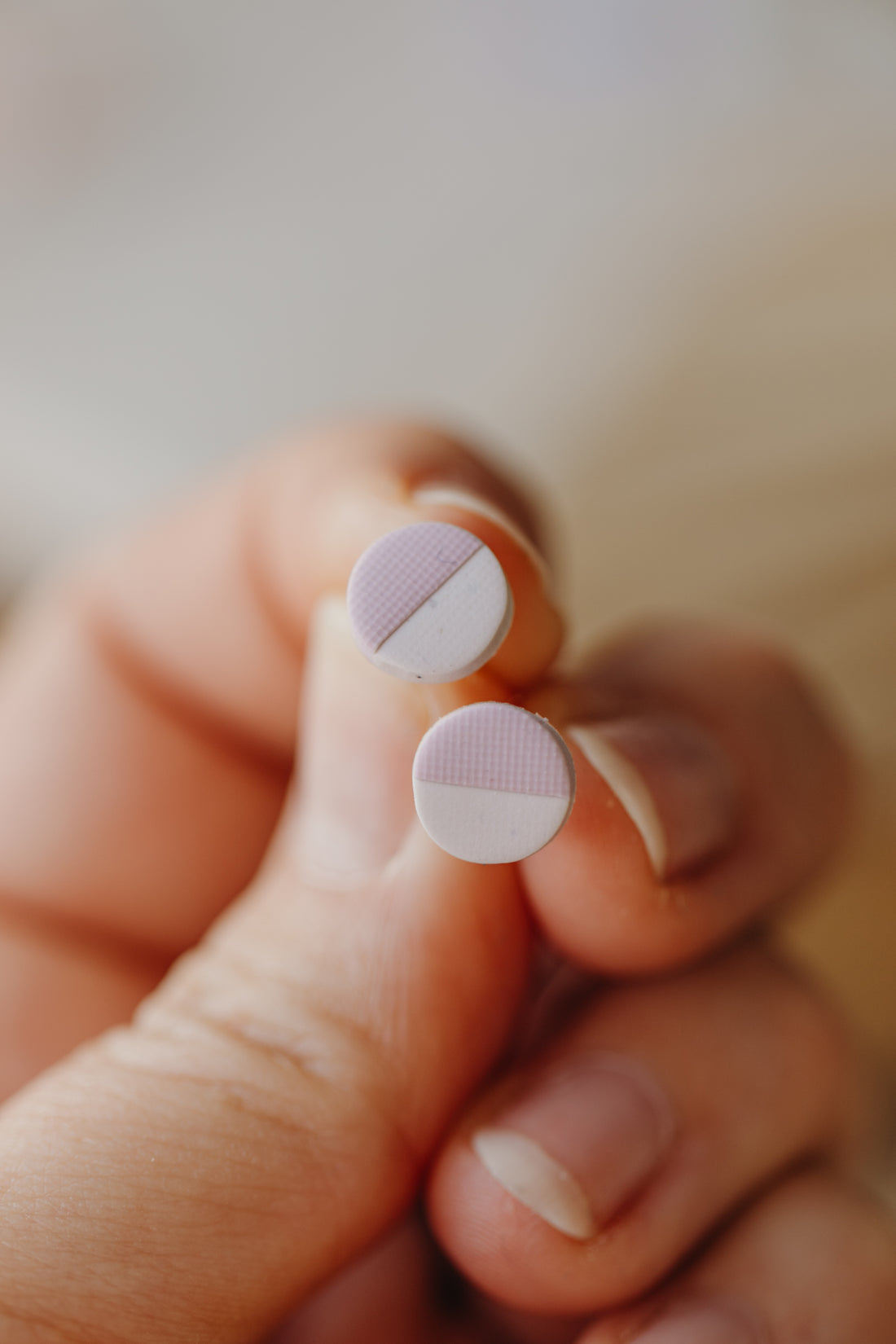 small round two-tone earrings made of polymer clay in pastel colors