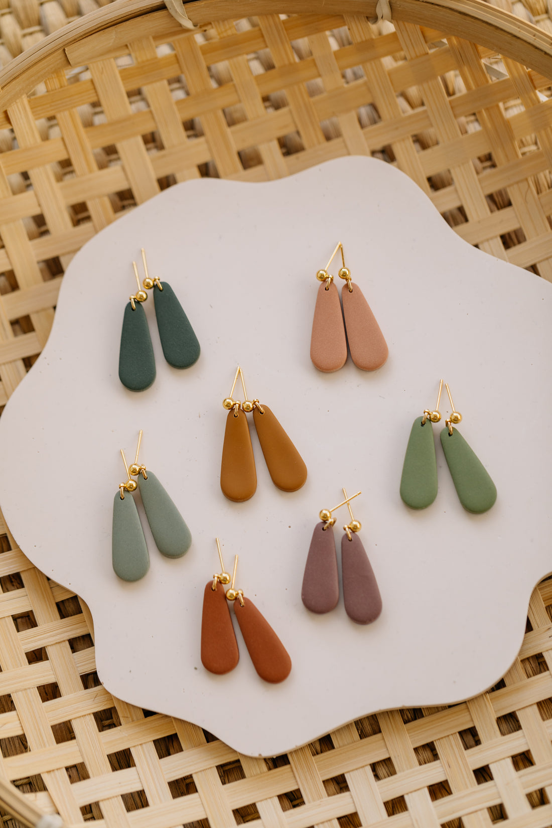 golden earrings with acrylic in white, petrol and brown